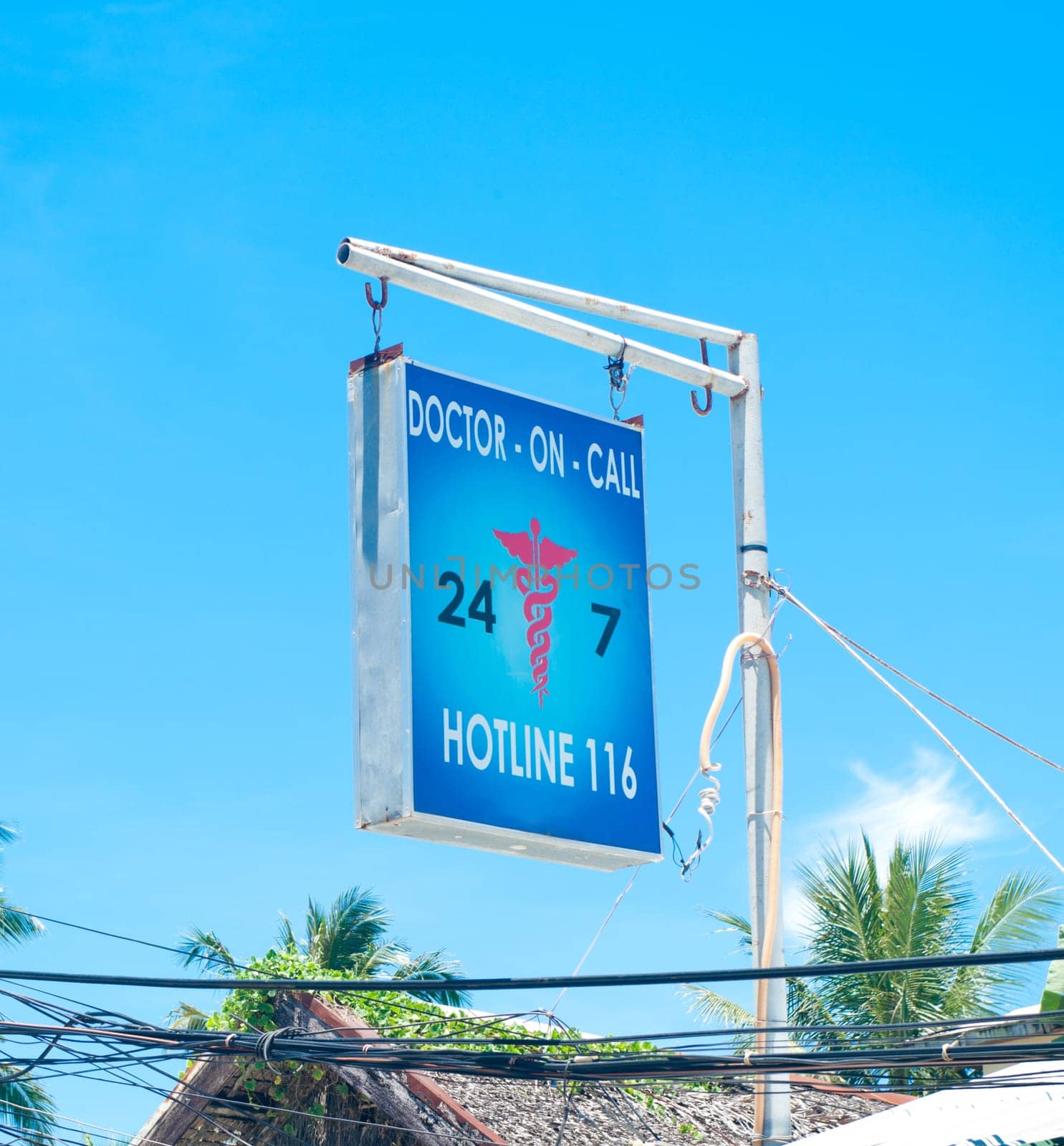 sign post with hotline alarm number for a doctor