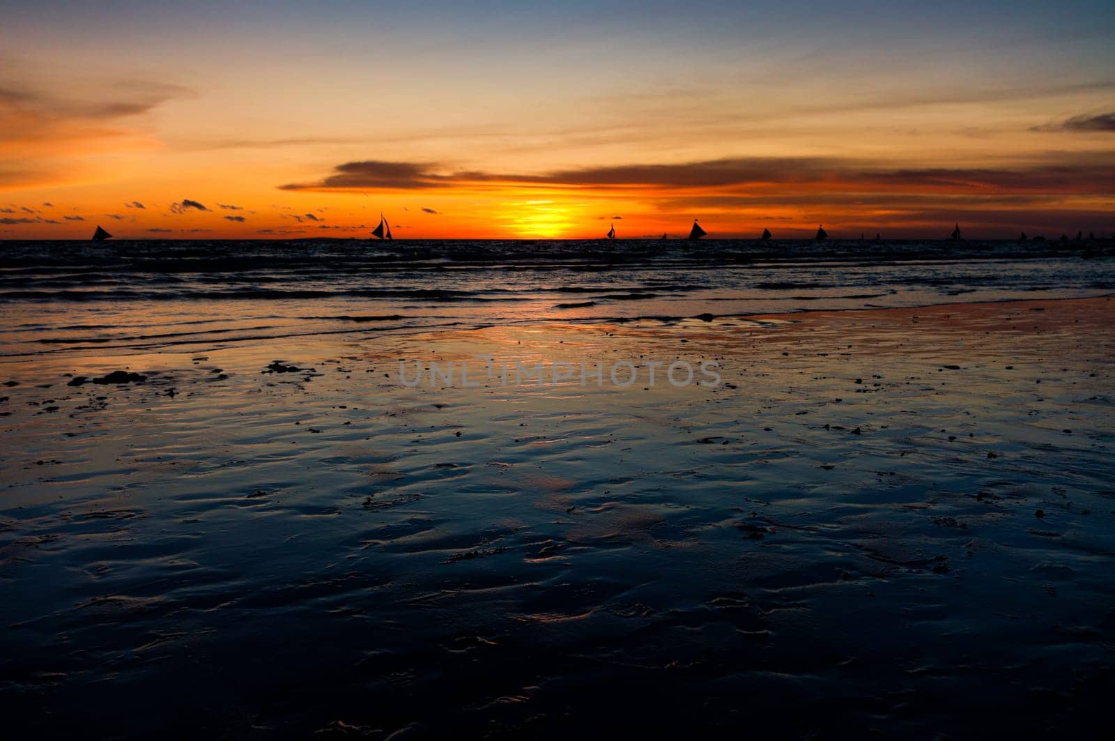 view over a tropical beach against a beautiful sunset