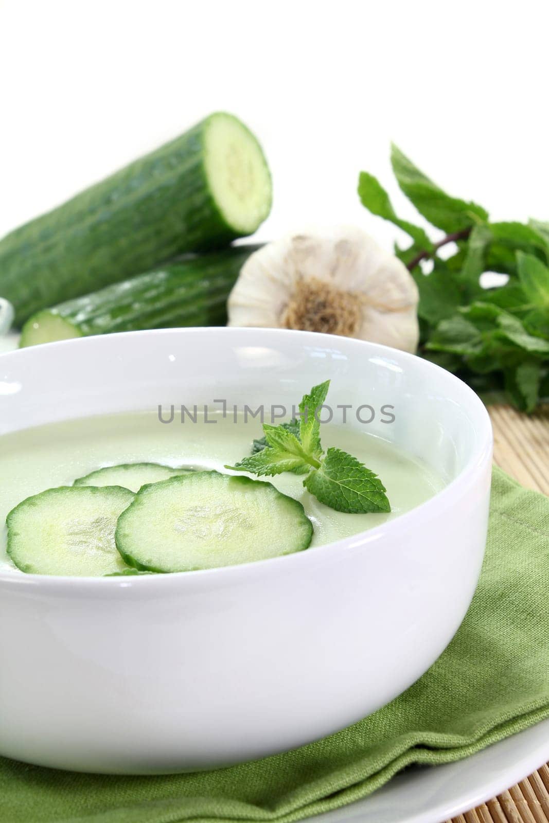 cold cucumber soup with cucumber slices and mint