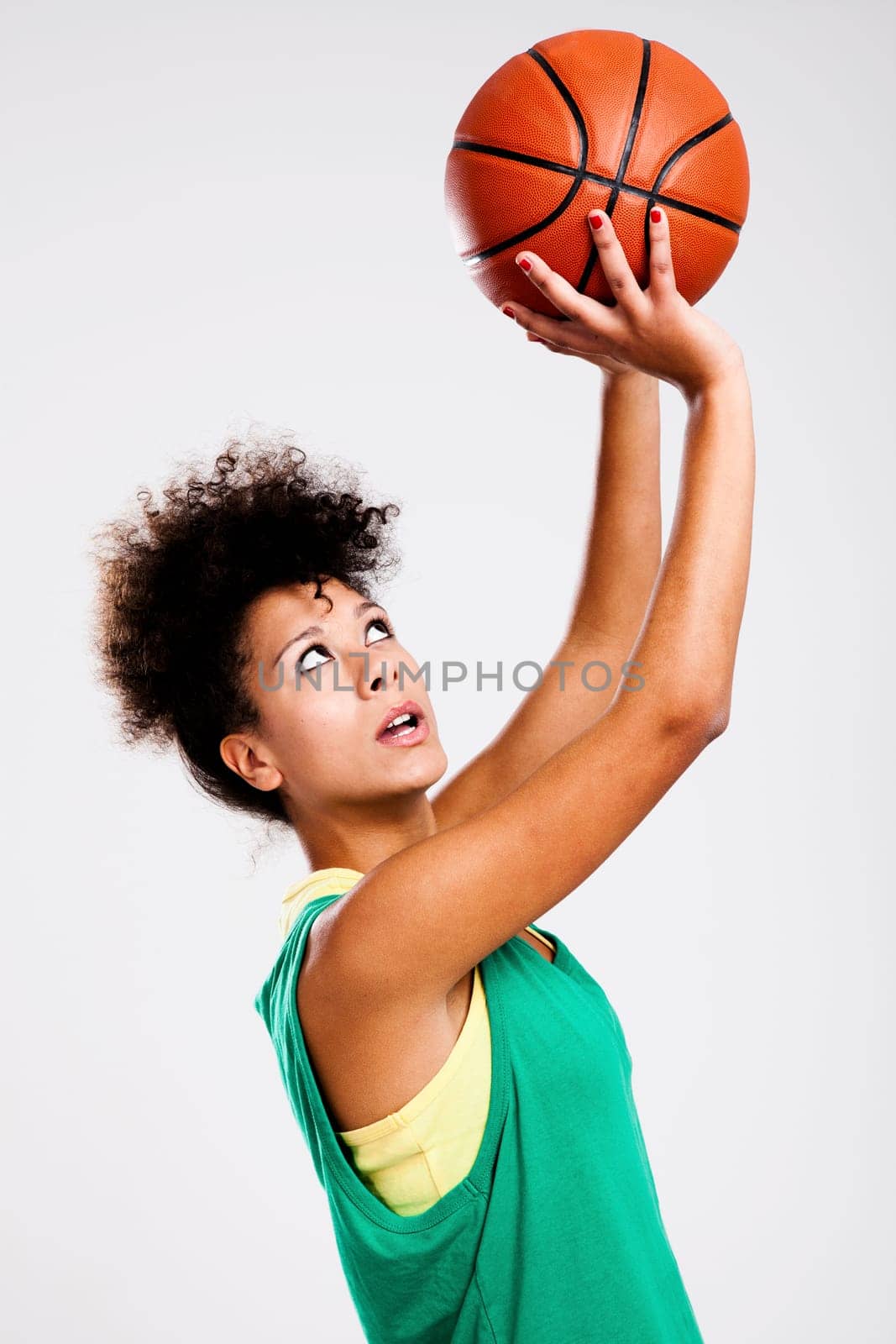 Beautiful athletic woman with basketball. Studio shot.
