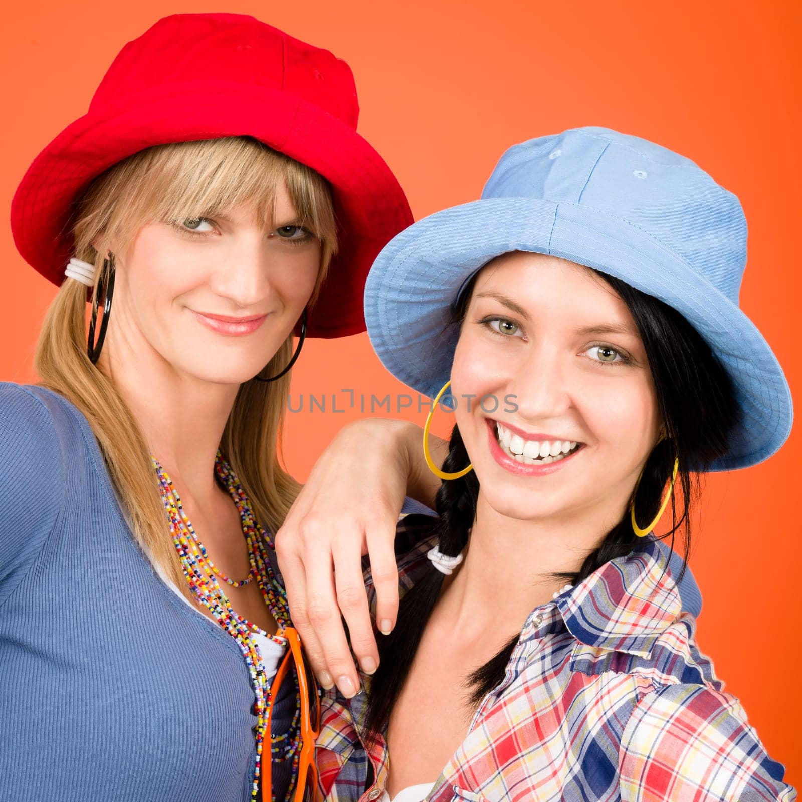Two woman friends young wear funny hats smiling crazy outfit