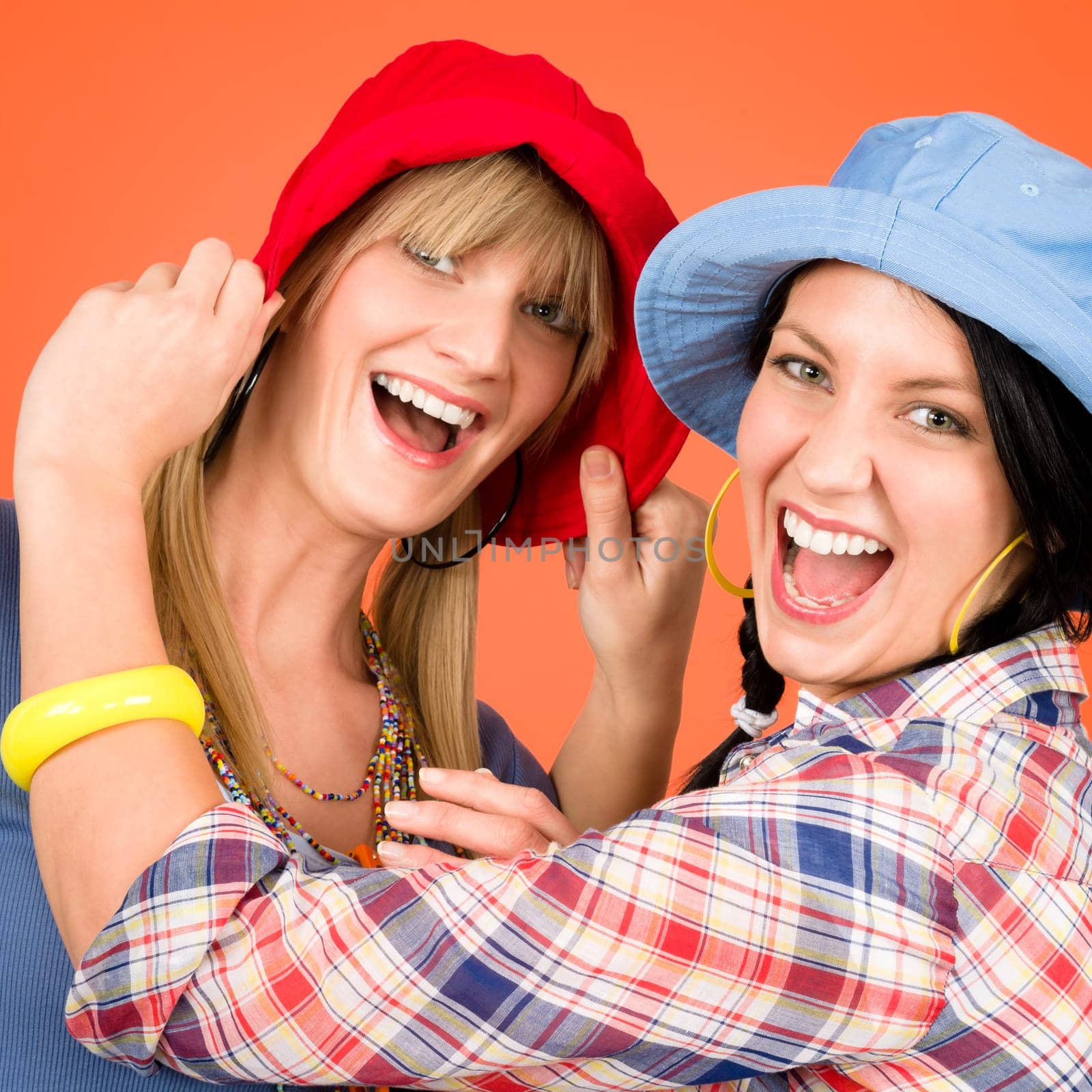 Two woman friends young wear funny hats smiling crazy outfit