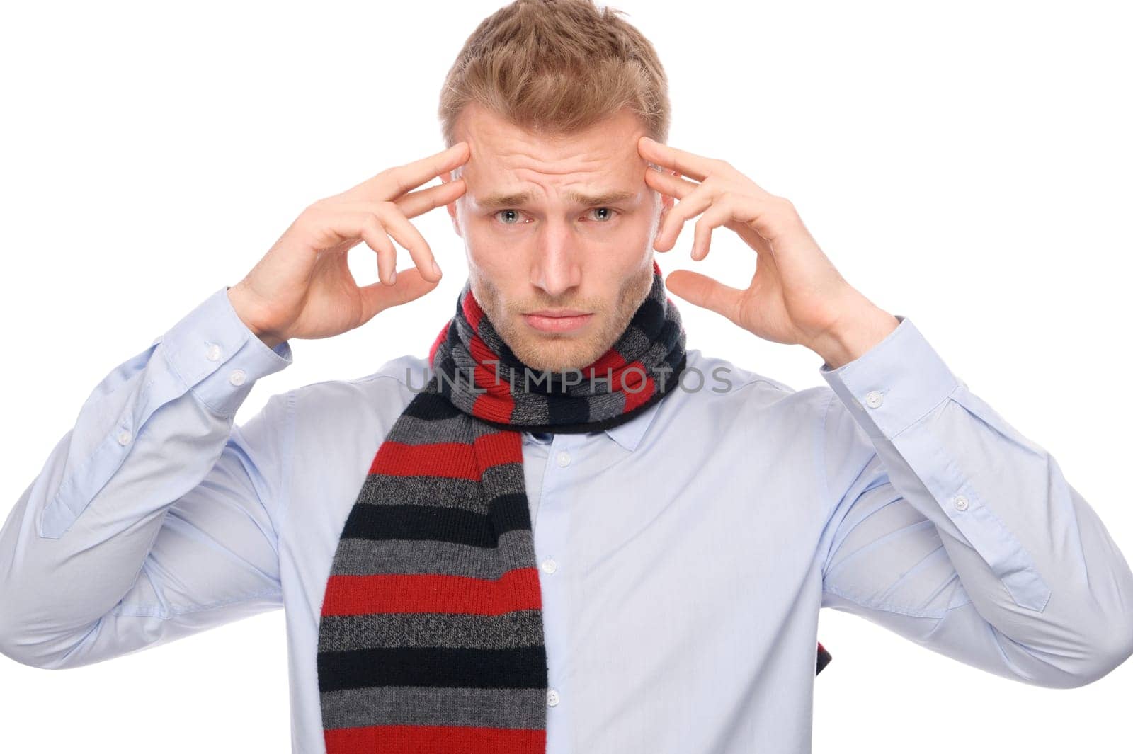 Studio shot of a young man with a headache