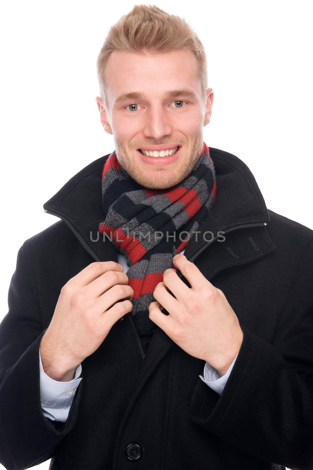 Studio shot of a young man with a scarf and a coat