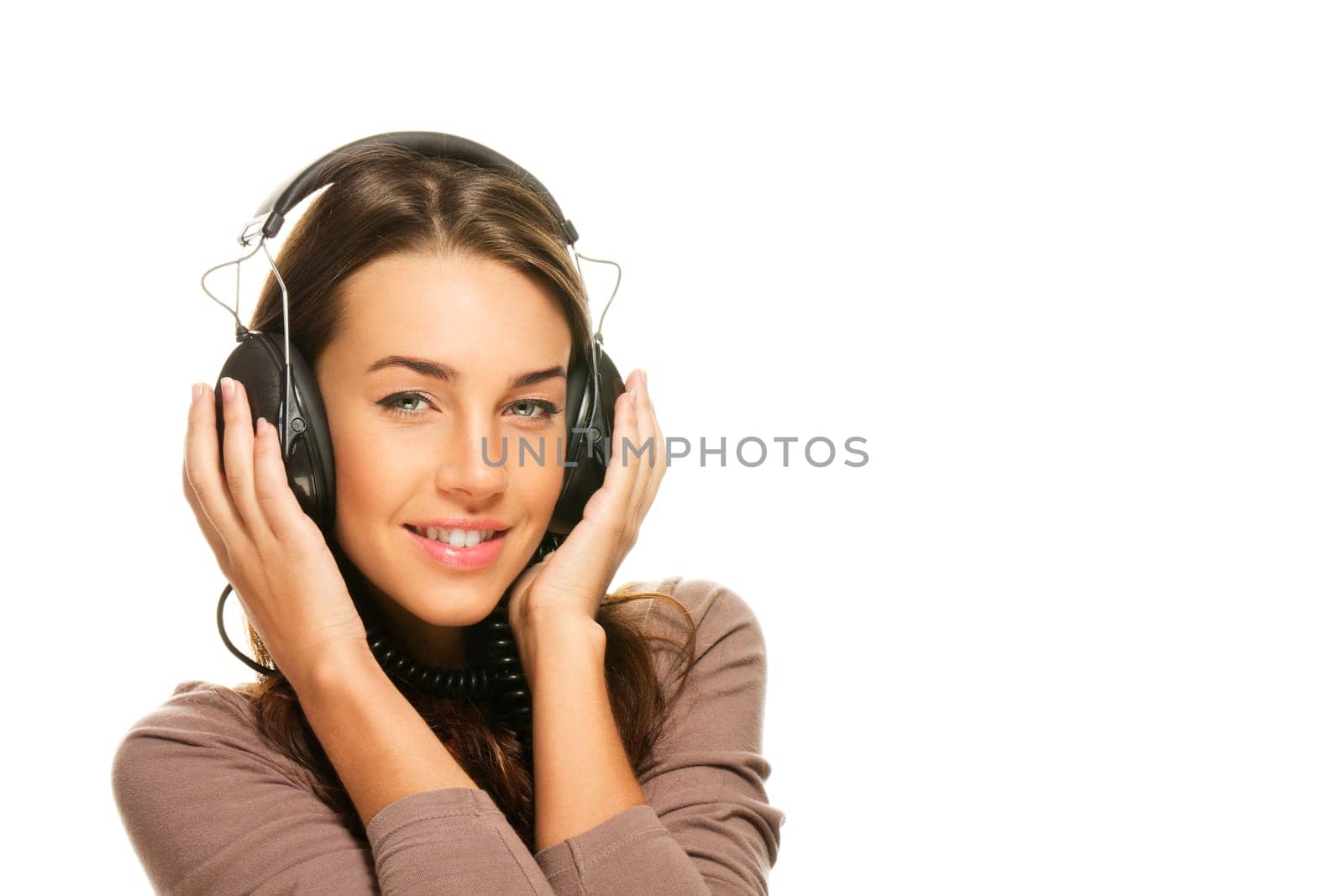 Happy young woman listening to music on white background
