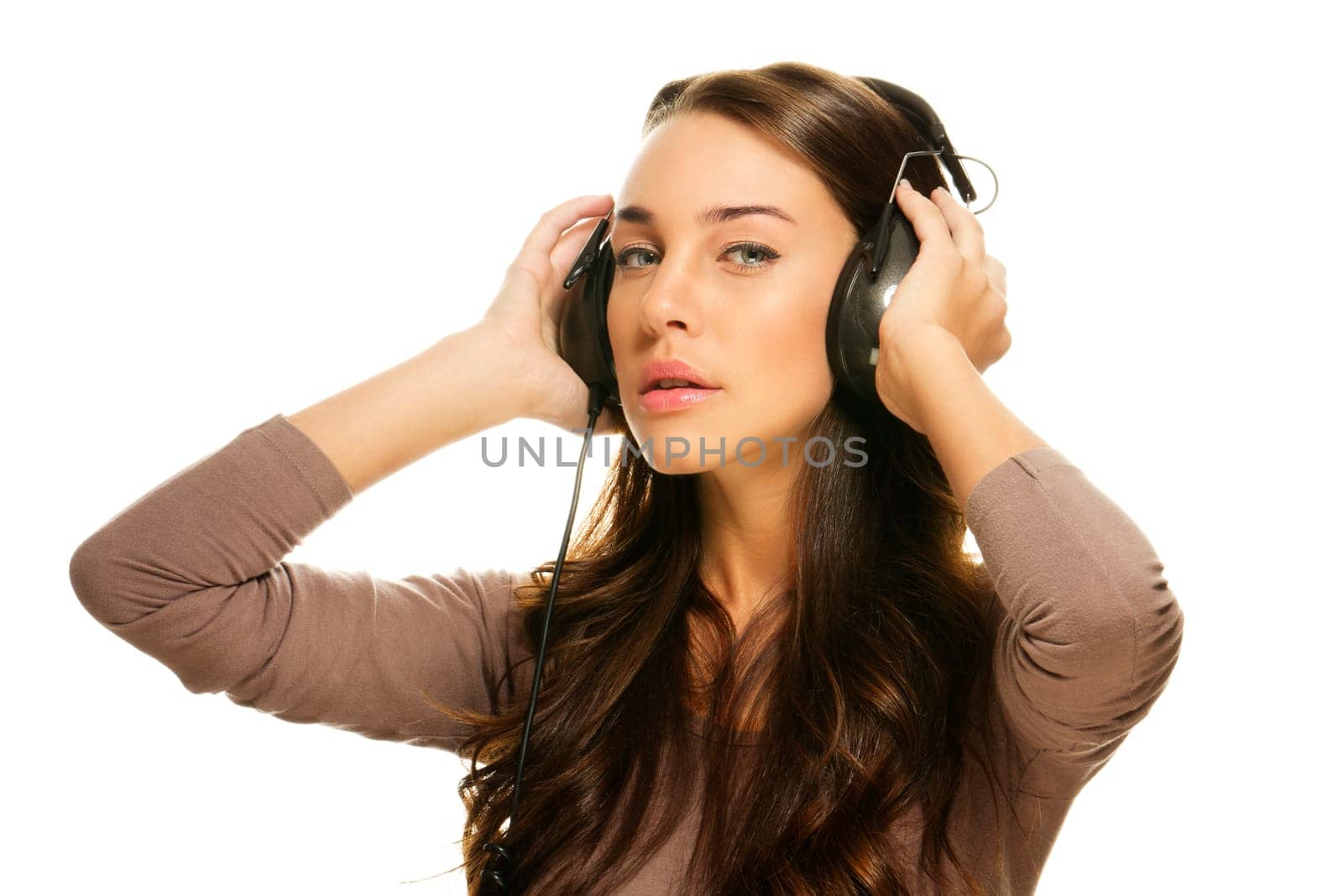 Young beautiful woman with headphones on white background