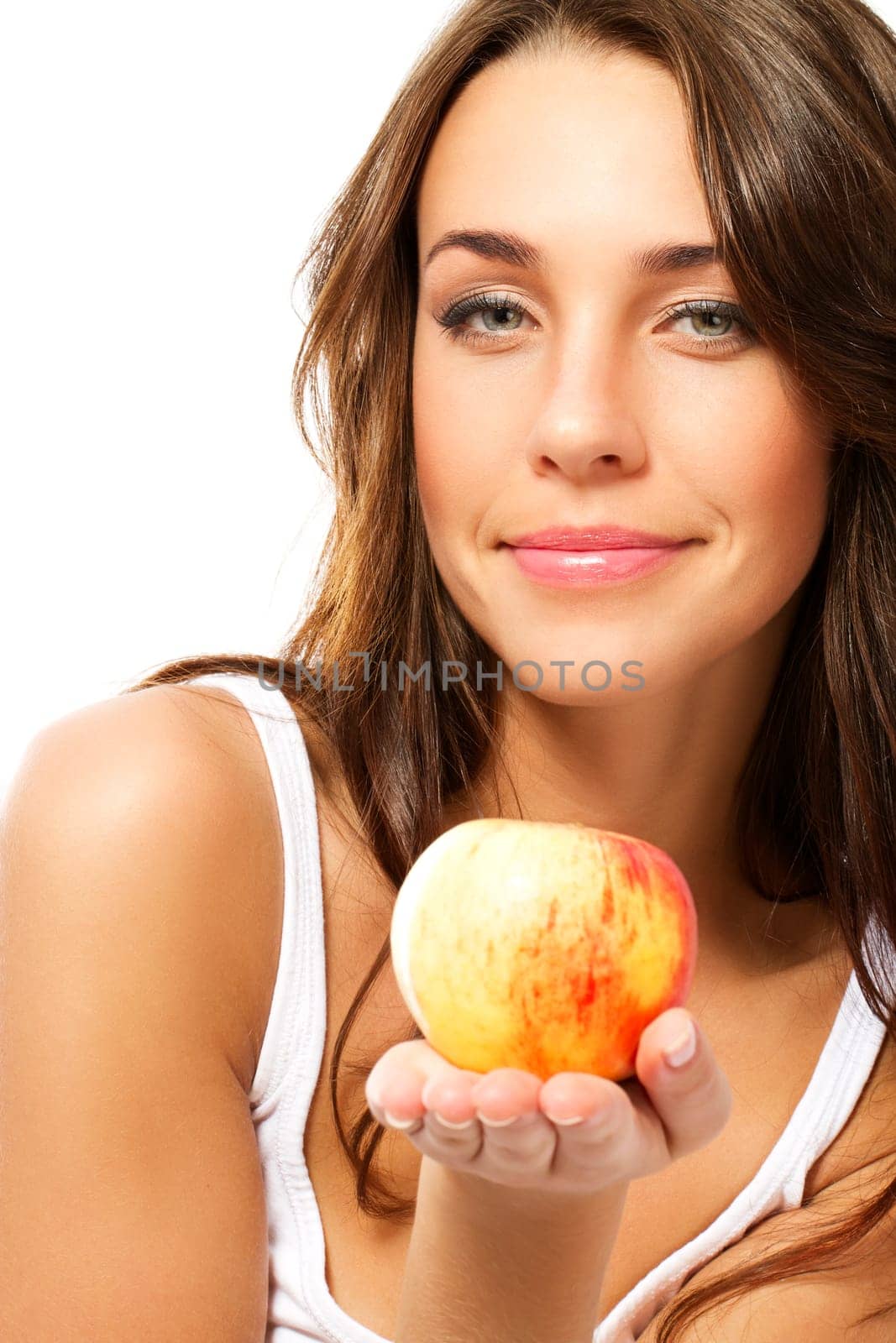 Young woman presenting an apple on a white background