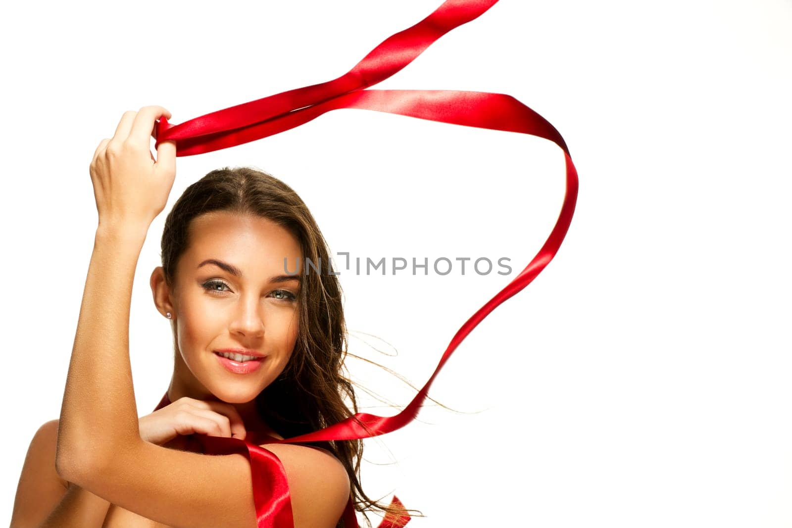 Happy woman playing with red ribbon on white background