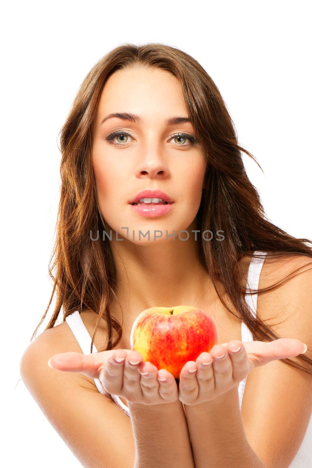 Young woman presenting an apple on a white background