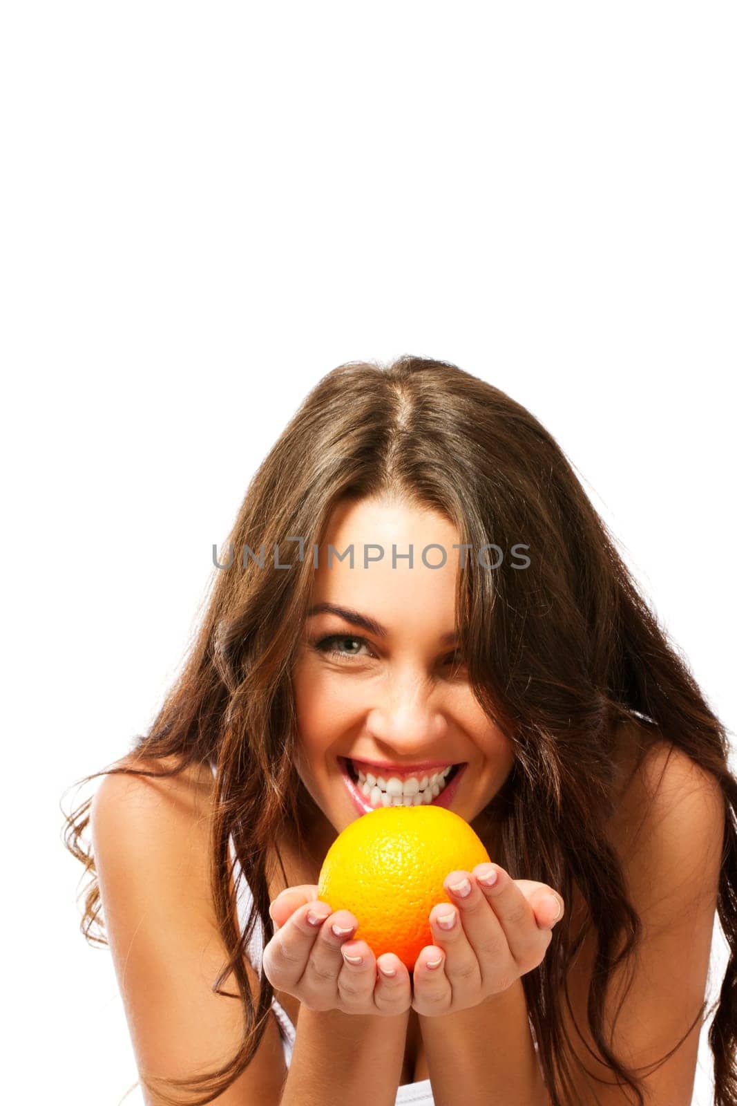 Young woman having fun with an orange on a white background