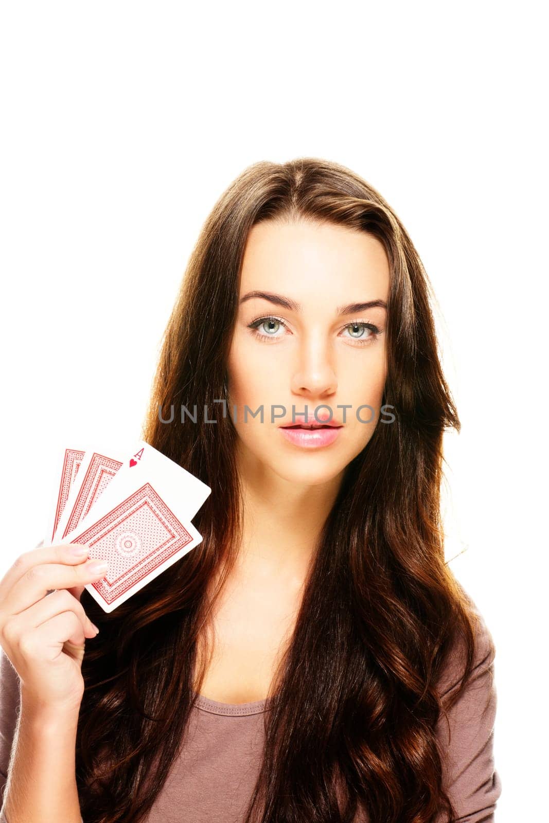 Young woman with poker cards on white background