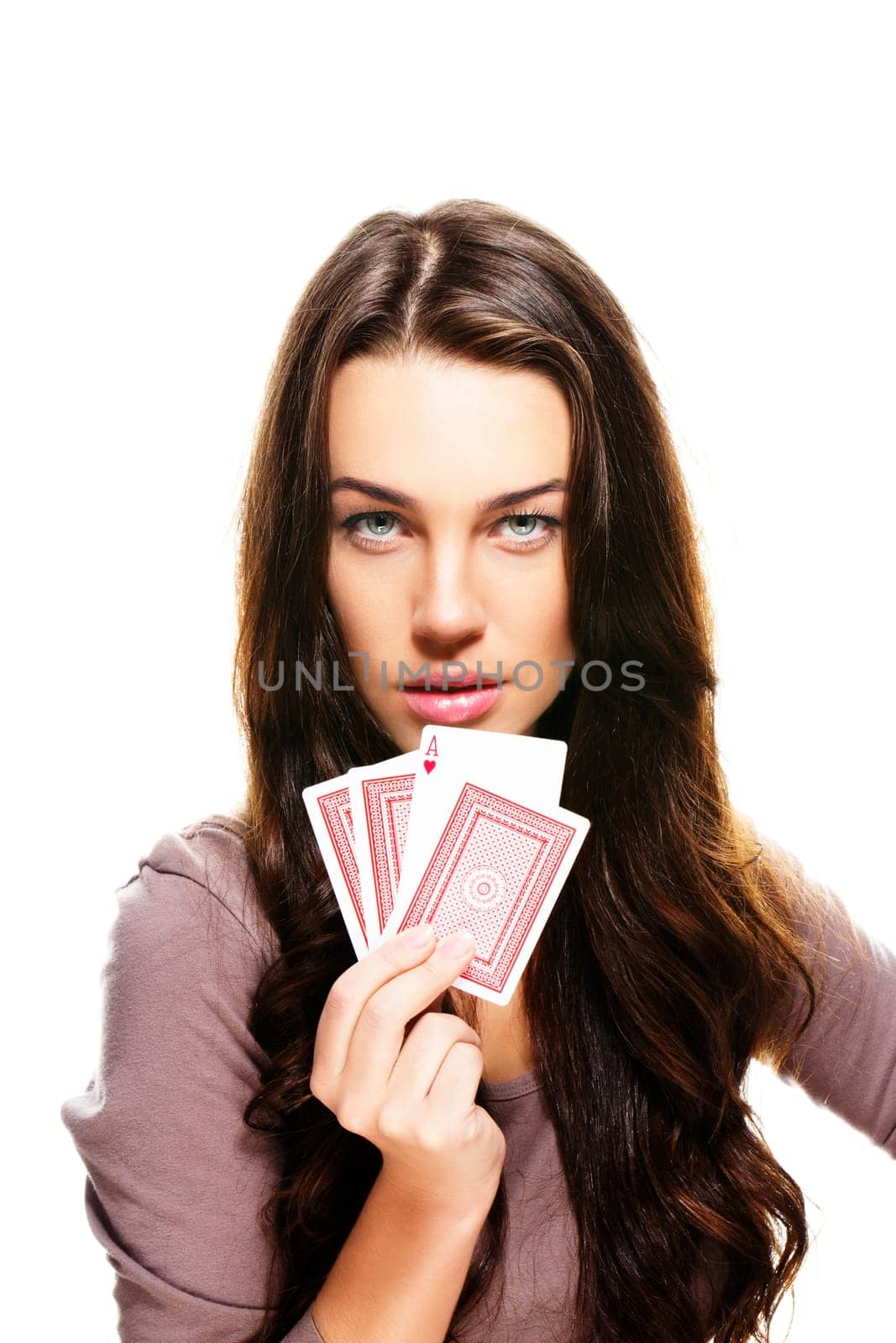 Young beautiful woman holding poker cards on white background