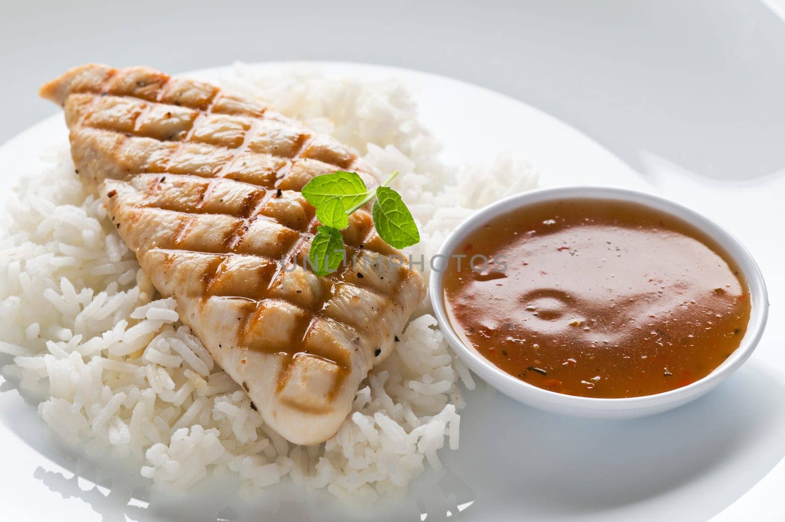 Grilled chicken steak with rice and hot sauce
