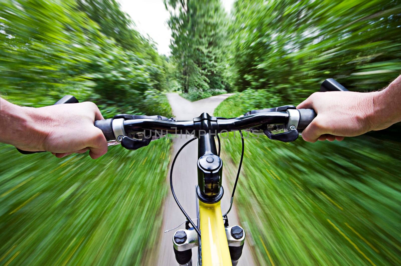 Mountain biking down hill descending fast close up