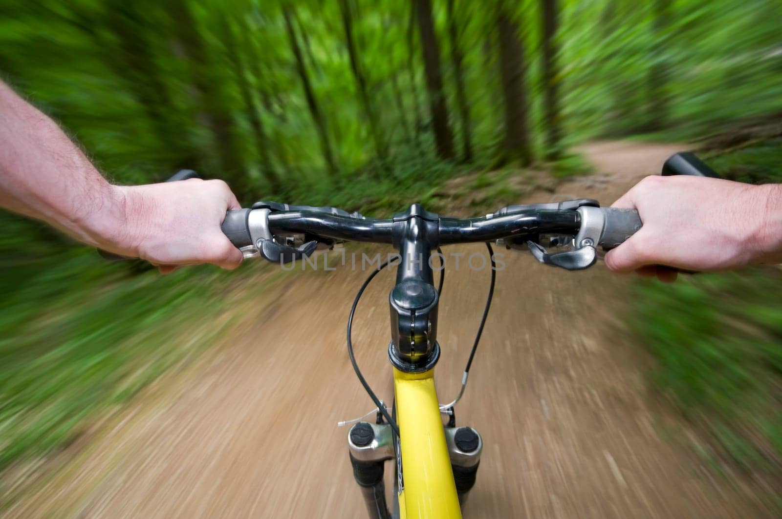 Mountain biking down hill descending fast close up