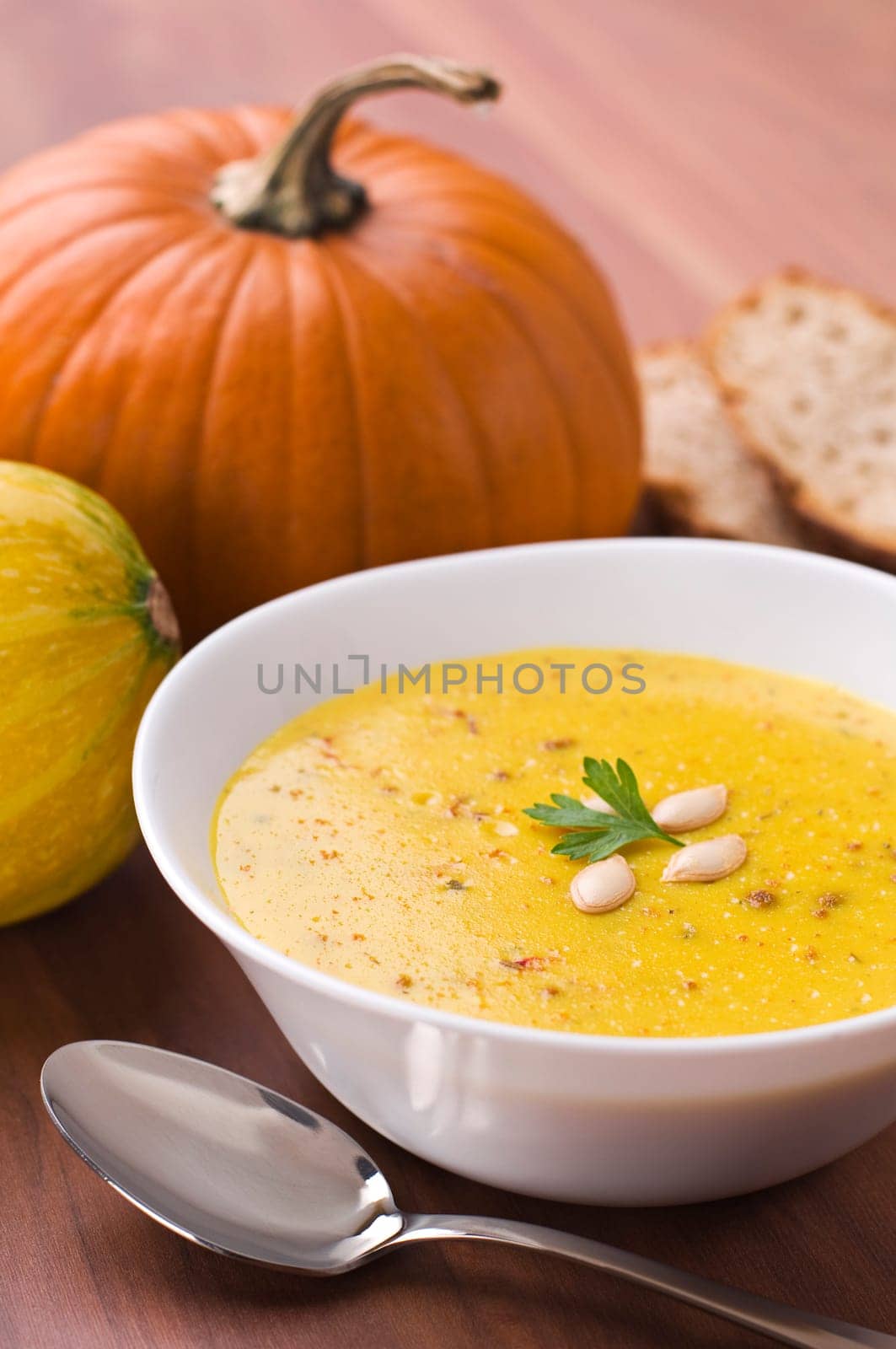 Fresh pumpkin soup with parsley close up