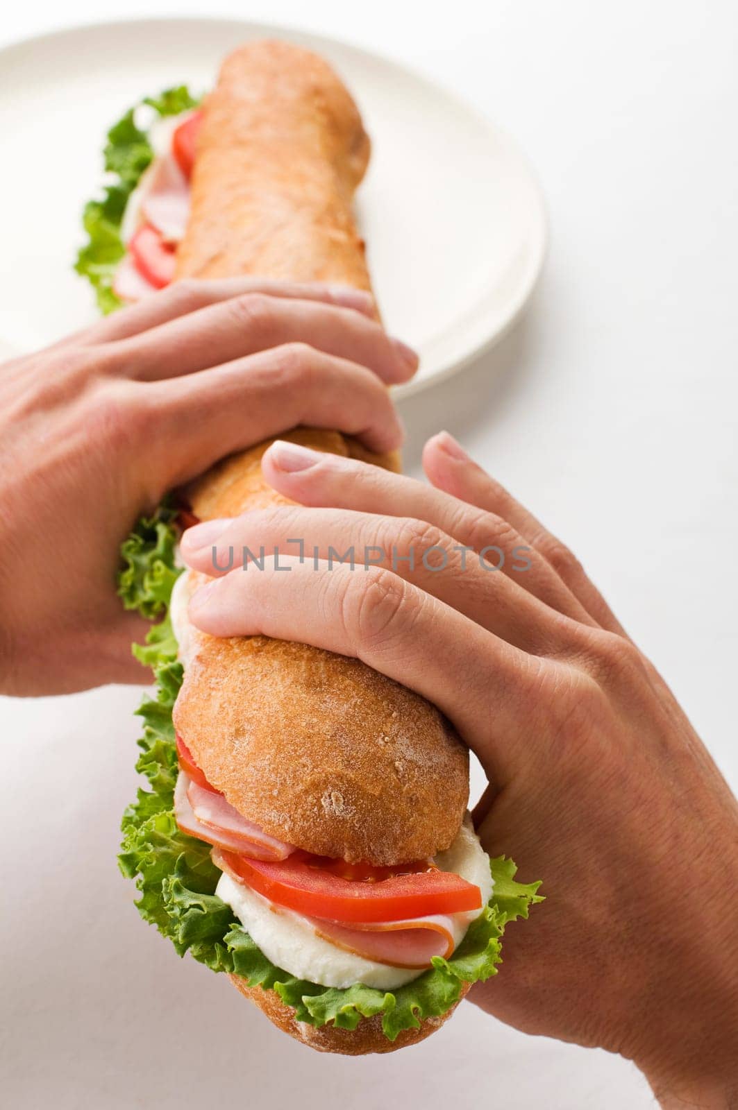 Man holding big sandwich close up shoot