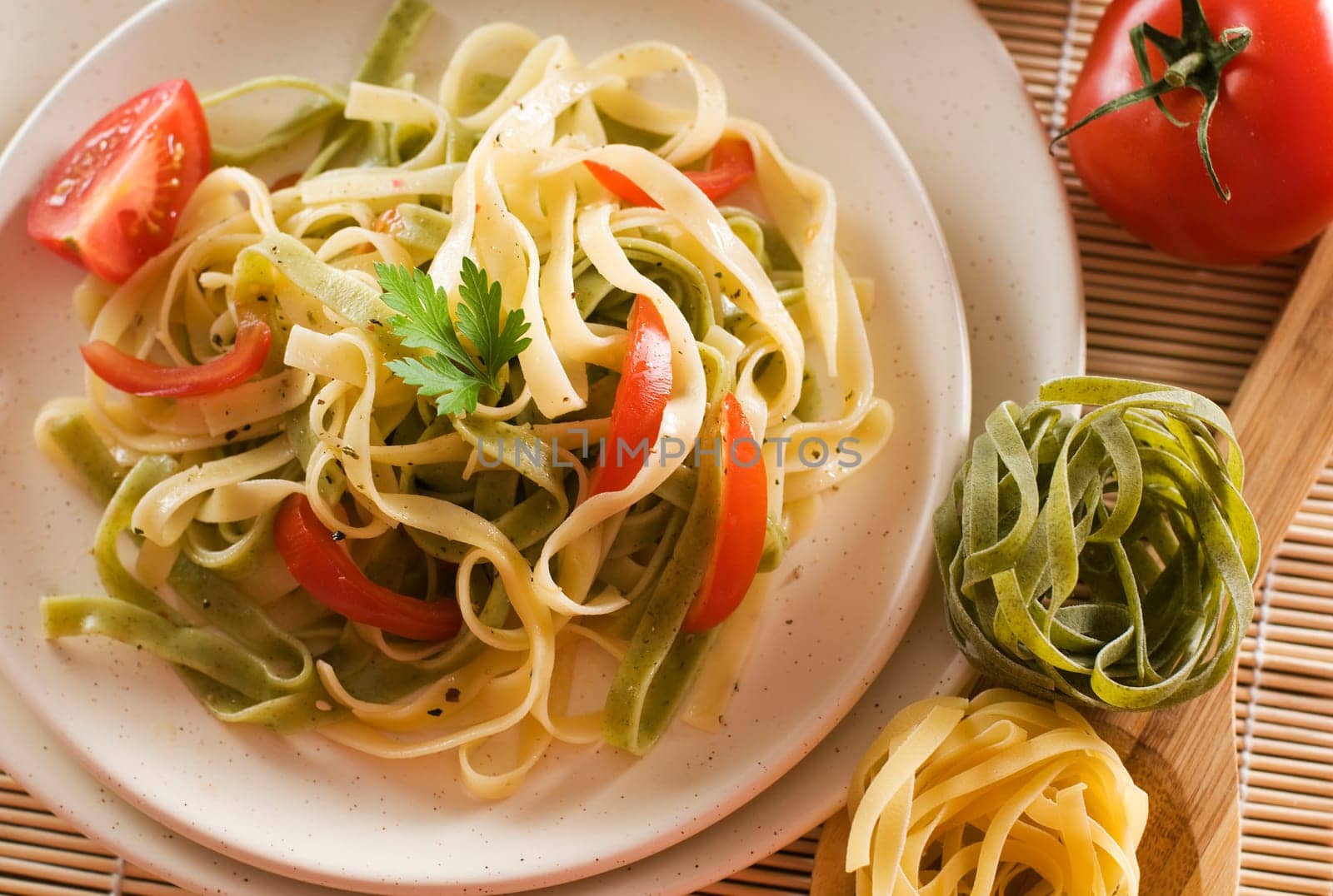 Mixed pasta with tomato and parsley close up shoot