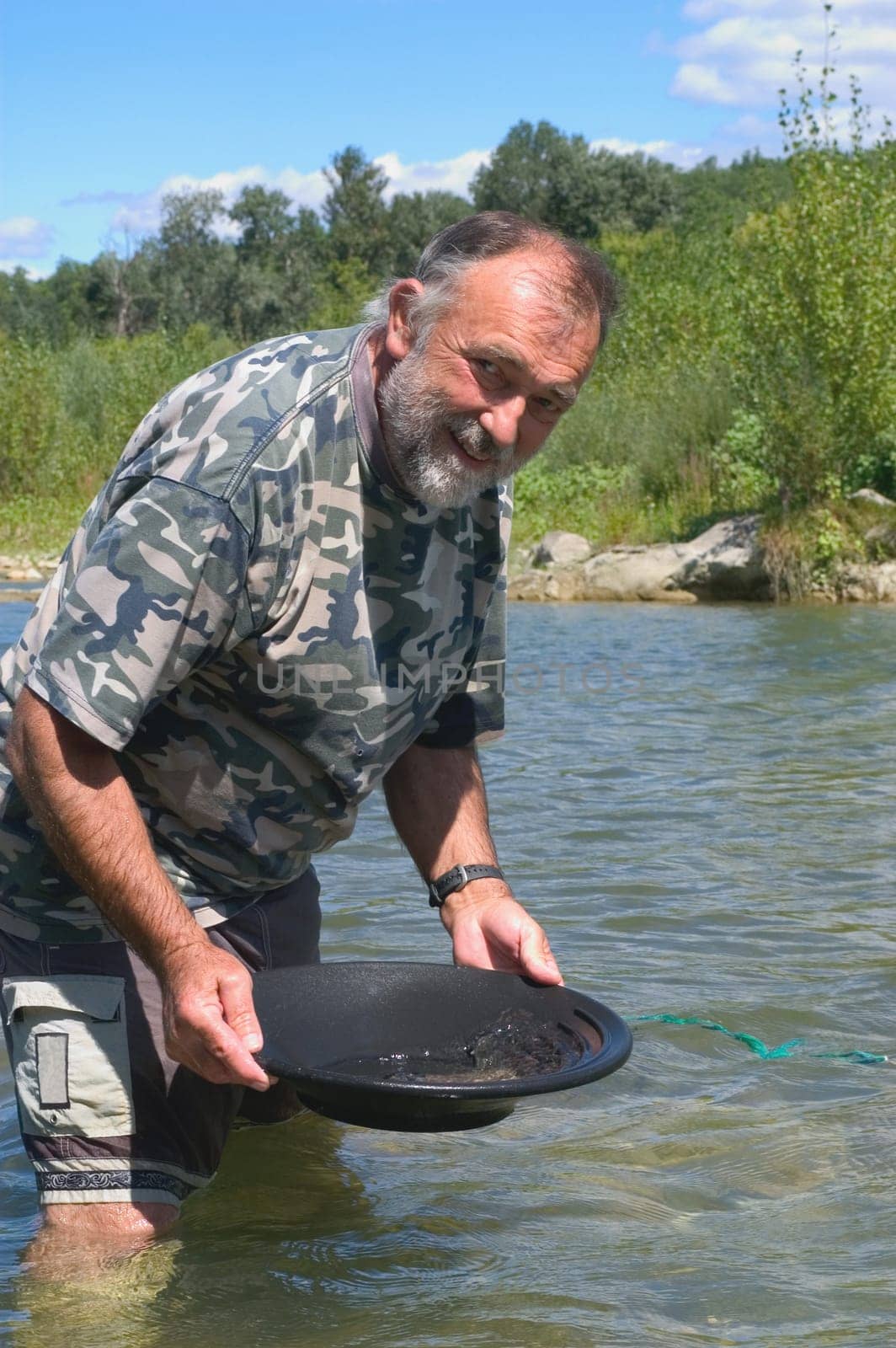 prospector panning for gold in rivers in France in the Gard region