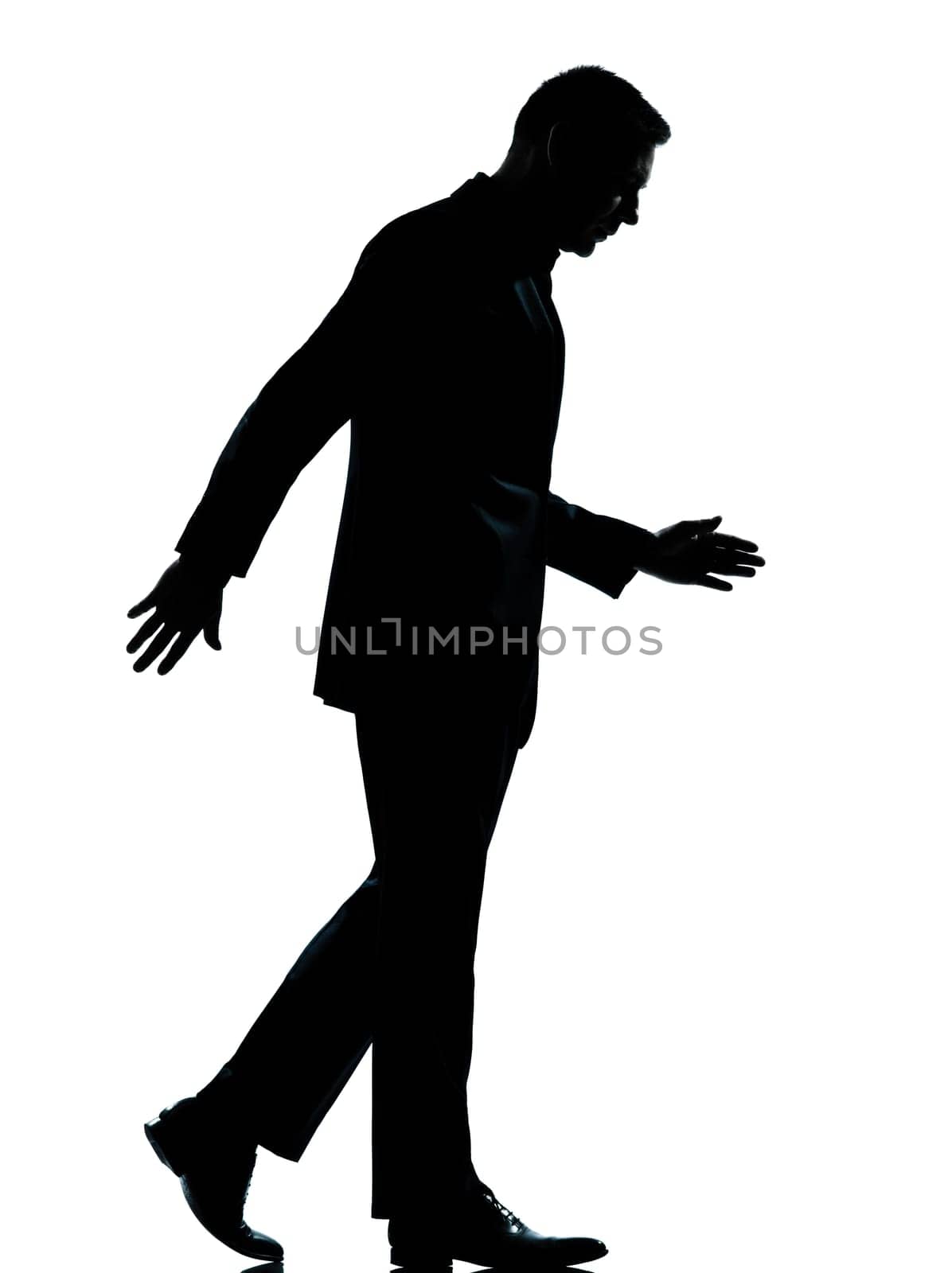 one caucasian business man walking silhouette Full length in studio isolated on white background