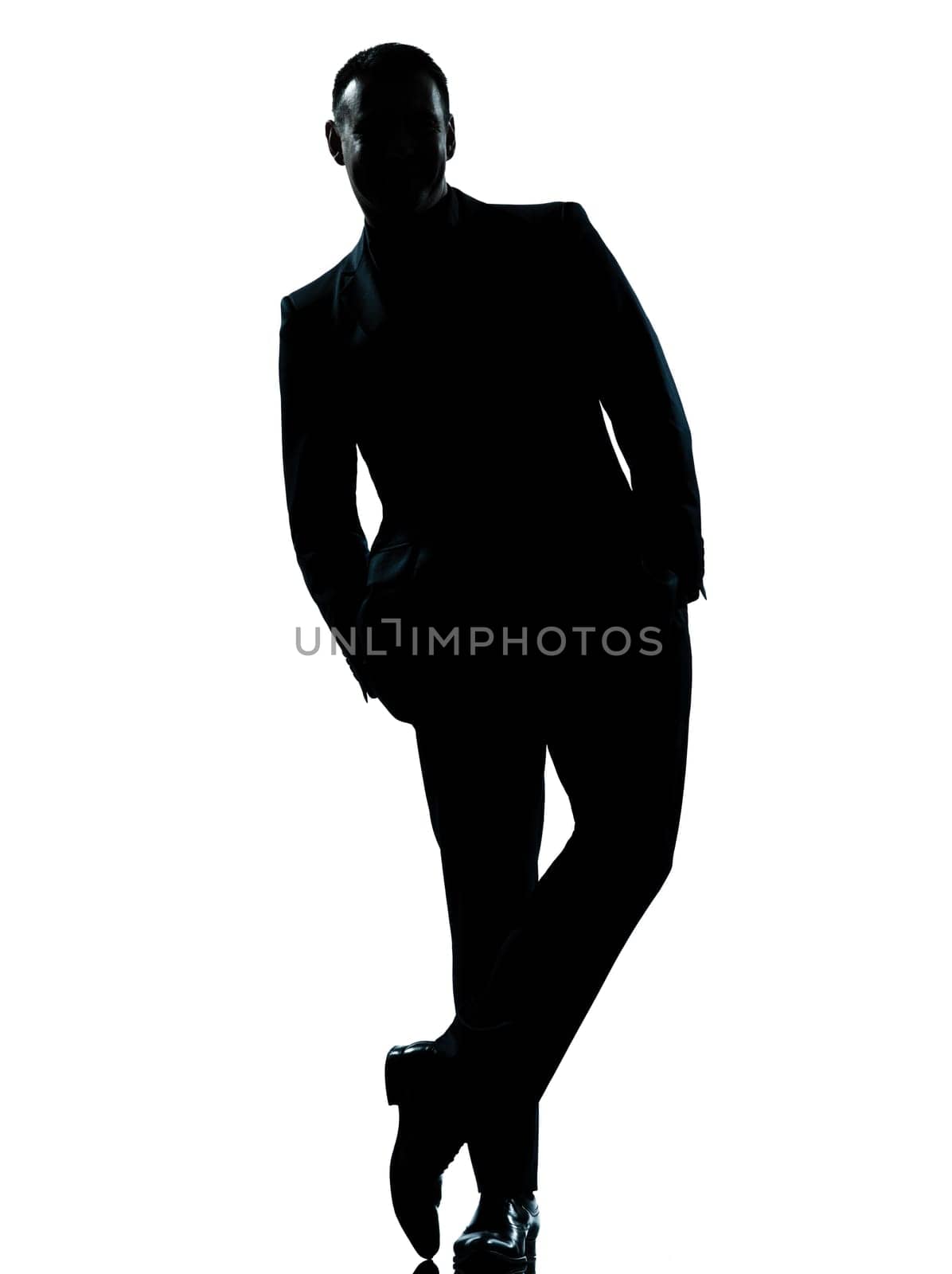 one caucasian business man silhouette standing Full length hands in pocket in studio isolated on white background