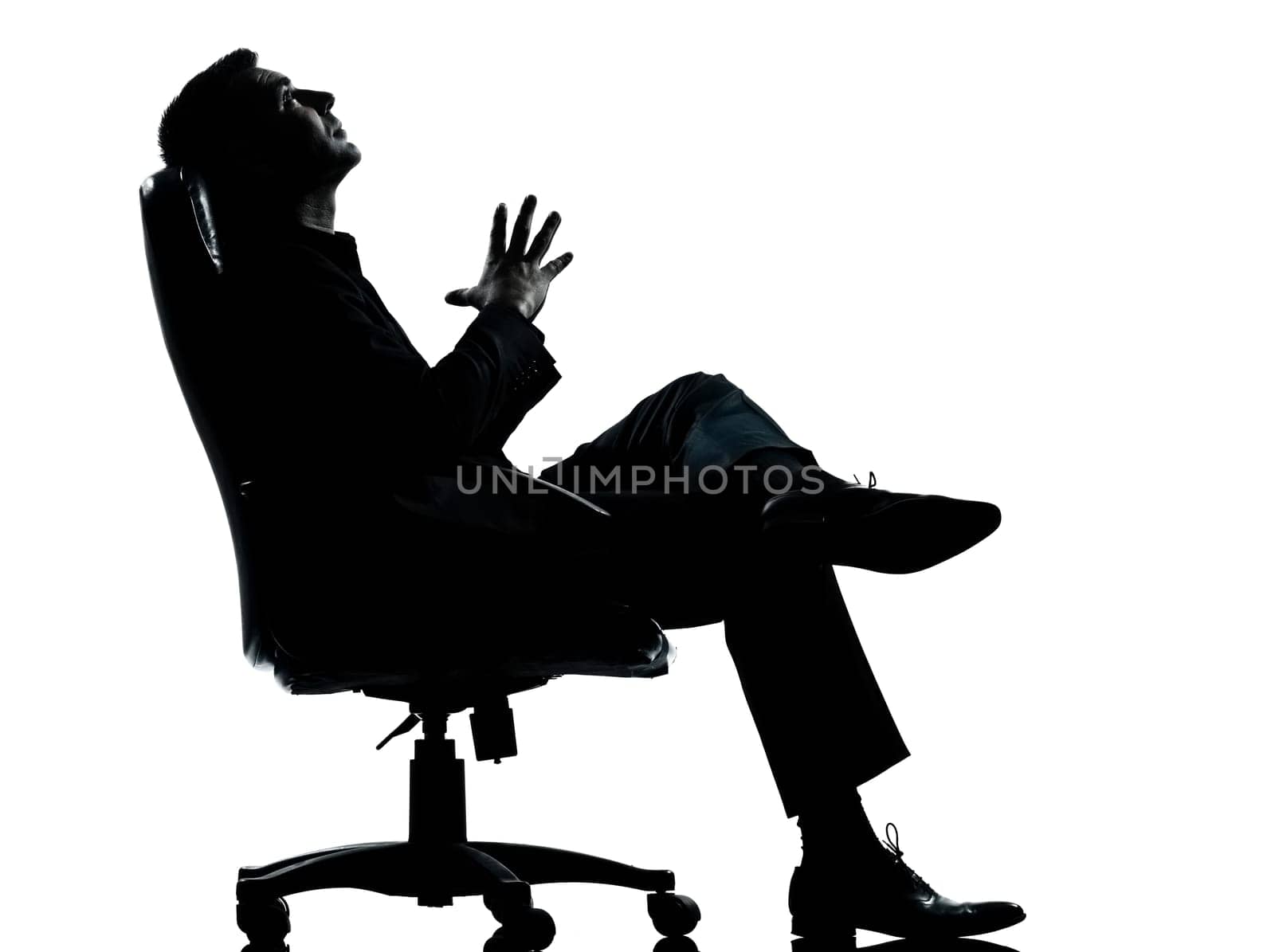 one caucasian business man relaxing thinking sitting in armchair silhouette Full length in studio isolated on white background