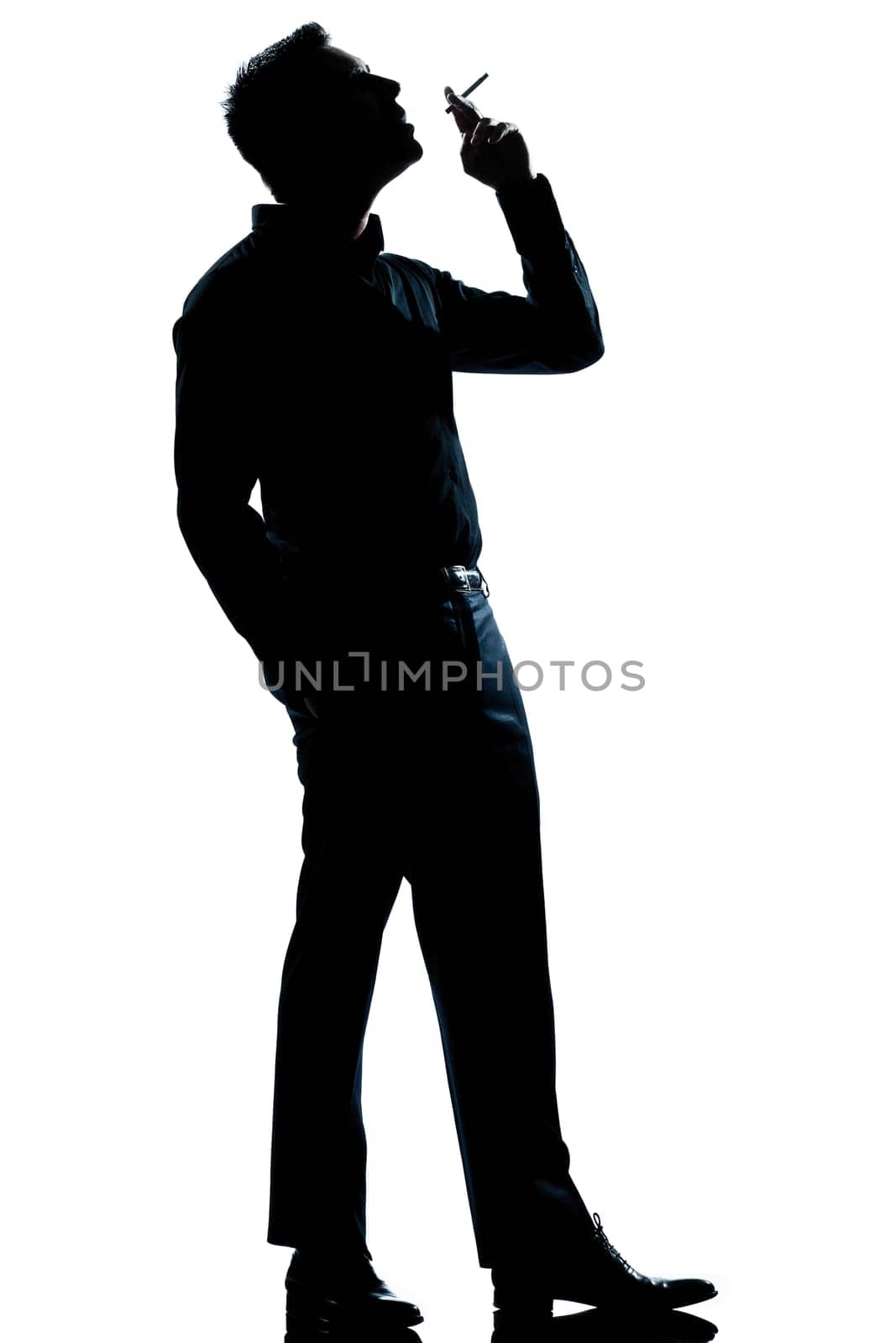 one caucasian man smoking cigarette full length silhouette in studio isolated white background