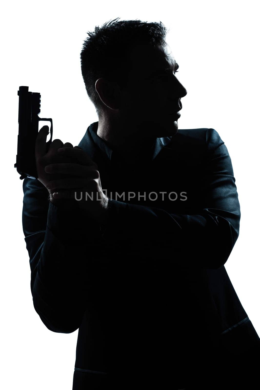 one caucasian spy criminal policeman detective man holding gun portrait silhouette in studio isolated white background