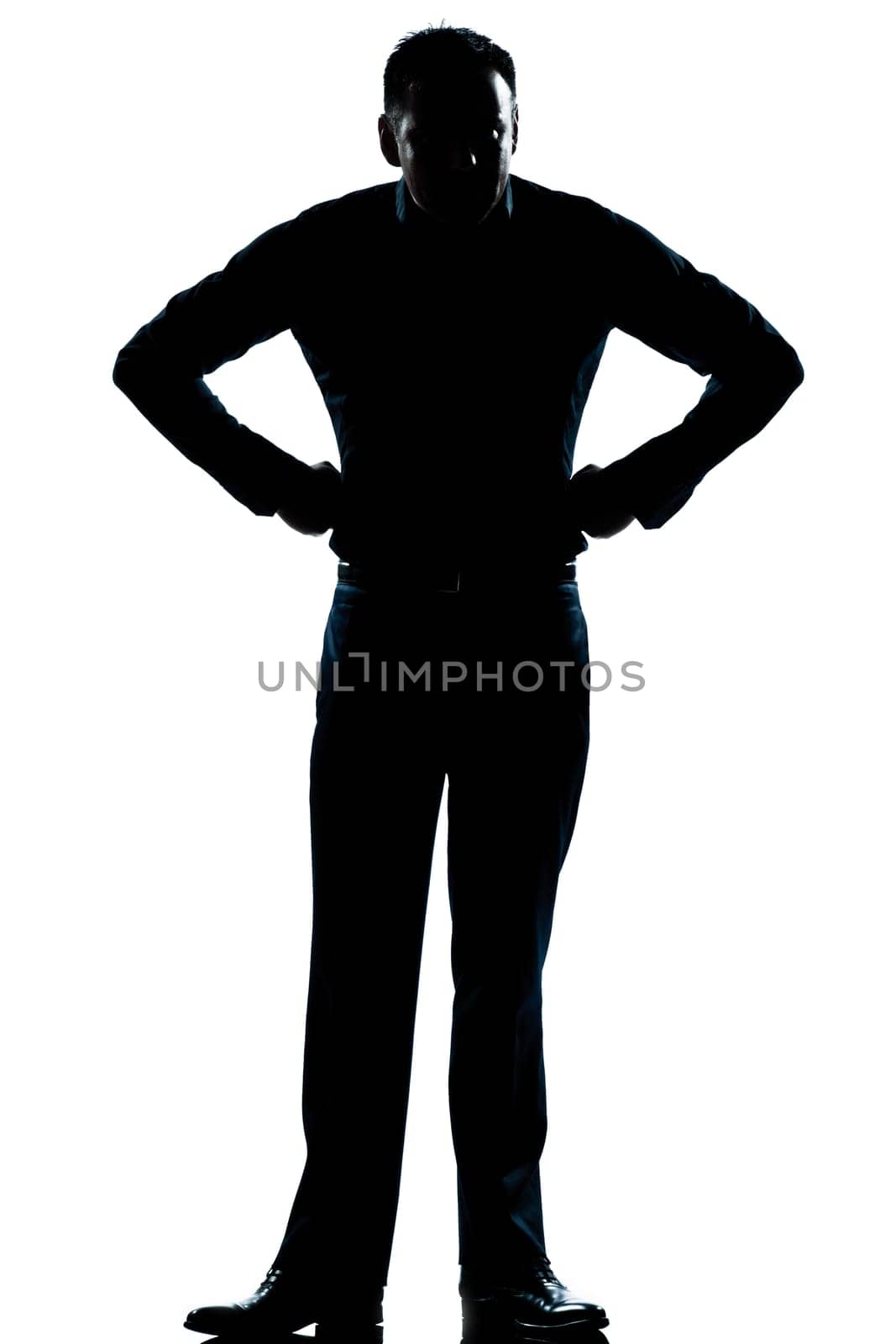 one caucasian man angry hands on hips full length silhouette in studio isolated white background