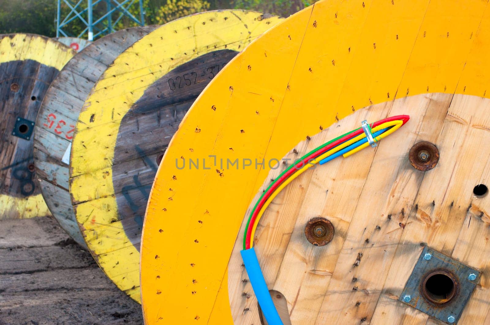 cable drums with several colored cables protected by a blue one.
