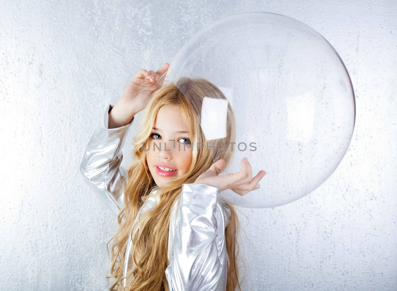 Astronaut futuristic kid girl with silver uniform and glass helmet