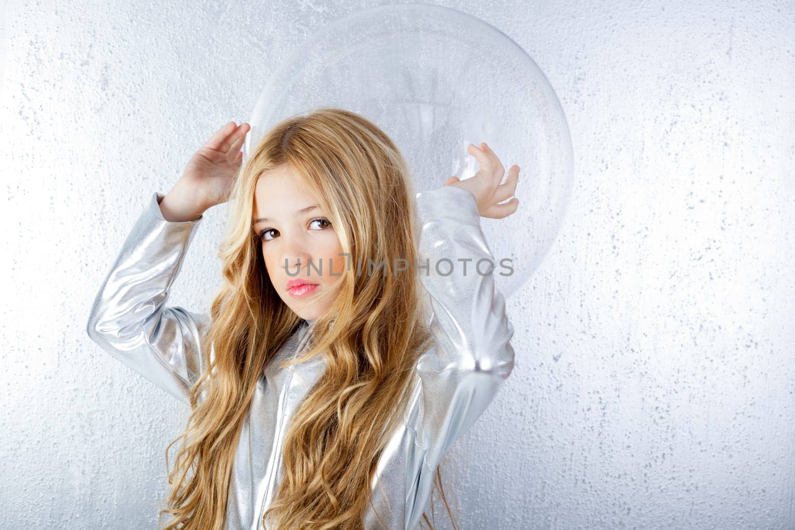 Astronaut futuristic kid girl with silver uniform and glass helmet