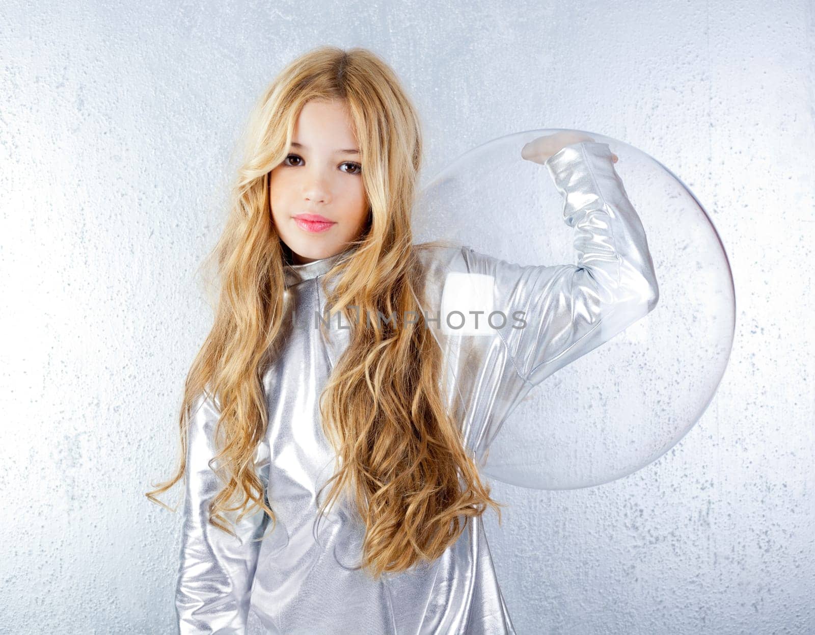 Astronaut futuristic kid girl with silver uniform and glass helmet