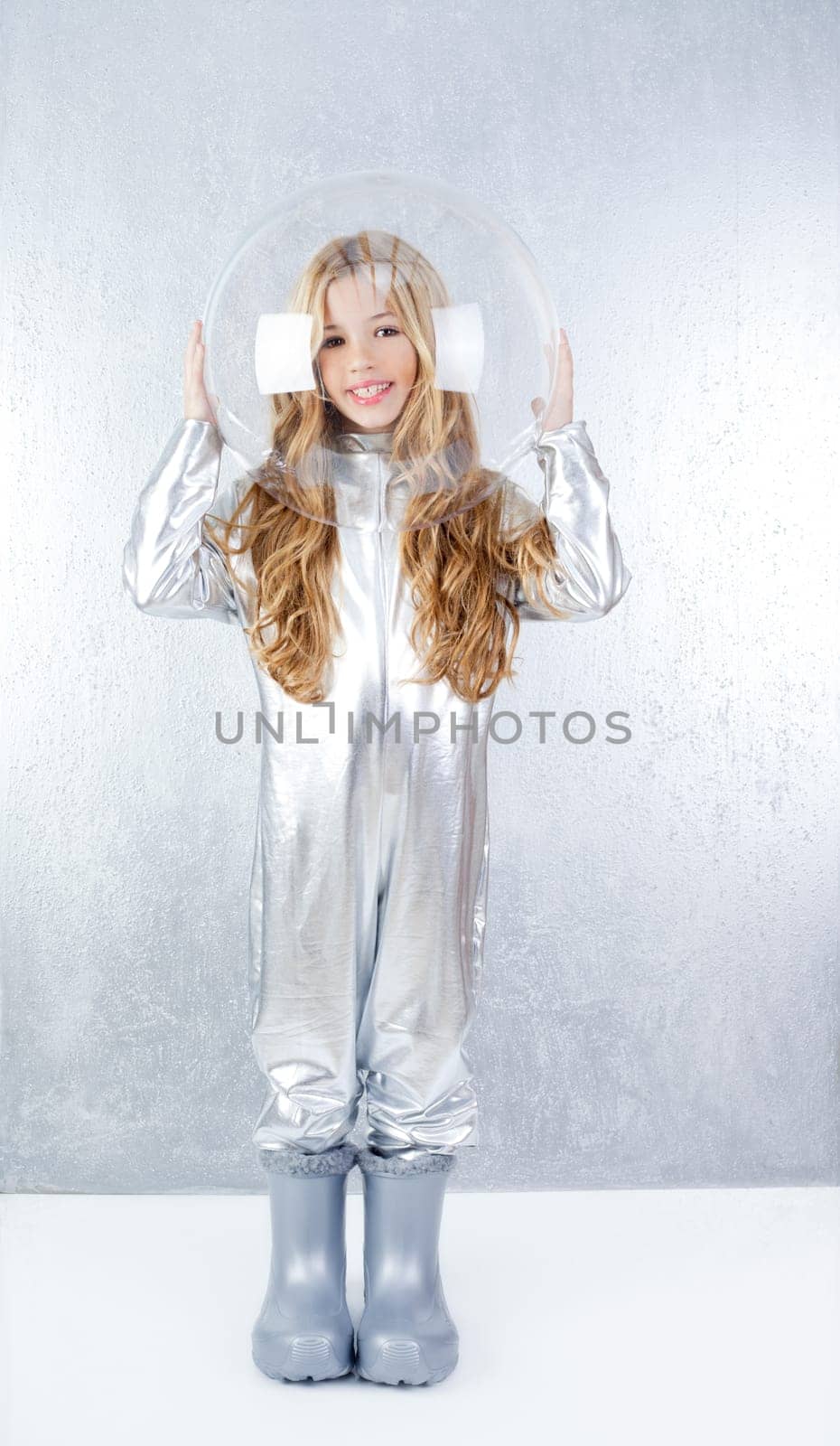 Astronaut futuristic kid girl with silver full length uniform and glass bubble helmet