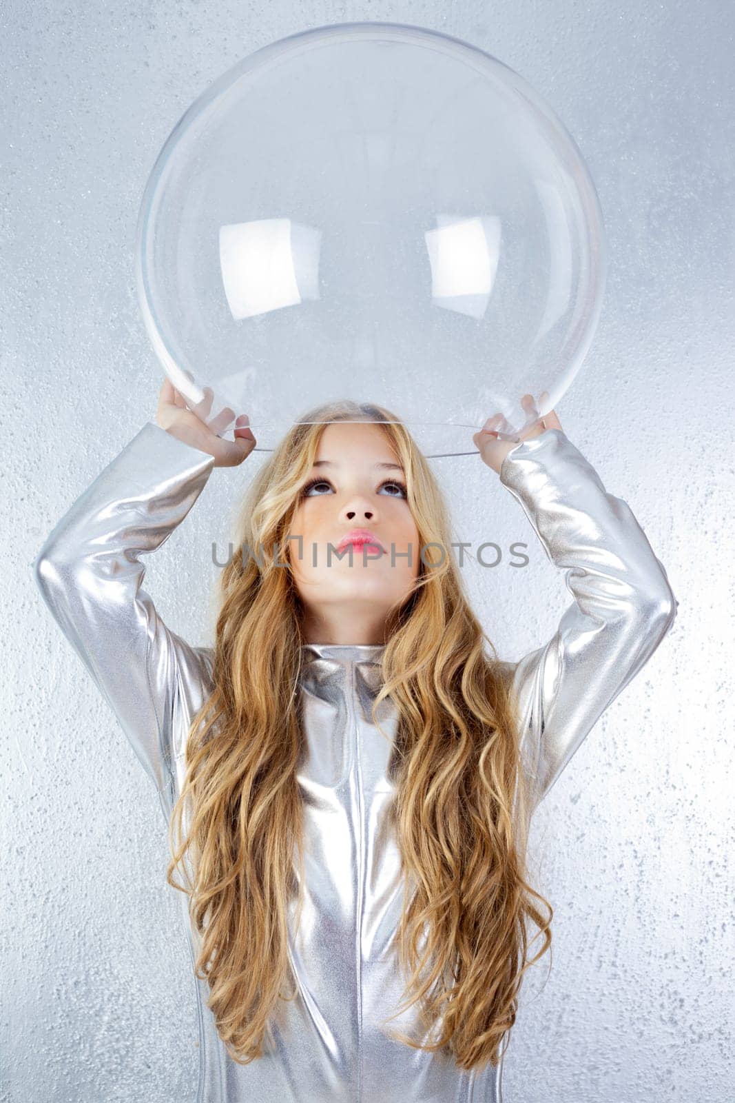 Astronaut futuristic kid girl with silver uniform and glass helmet