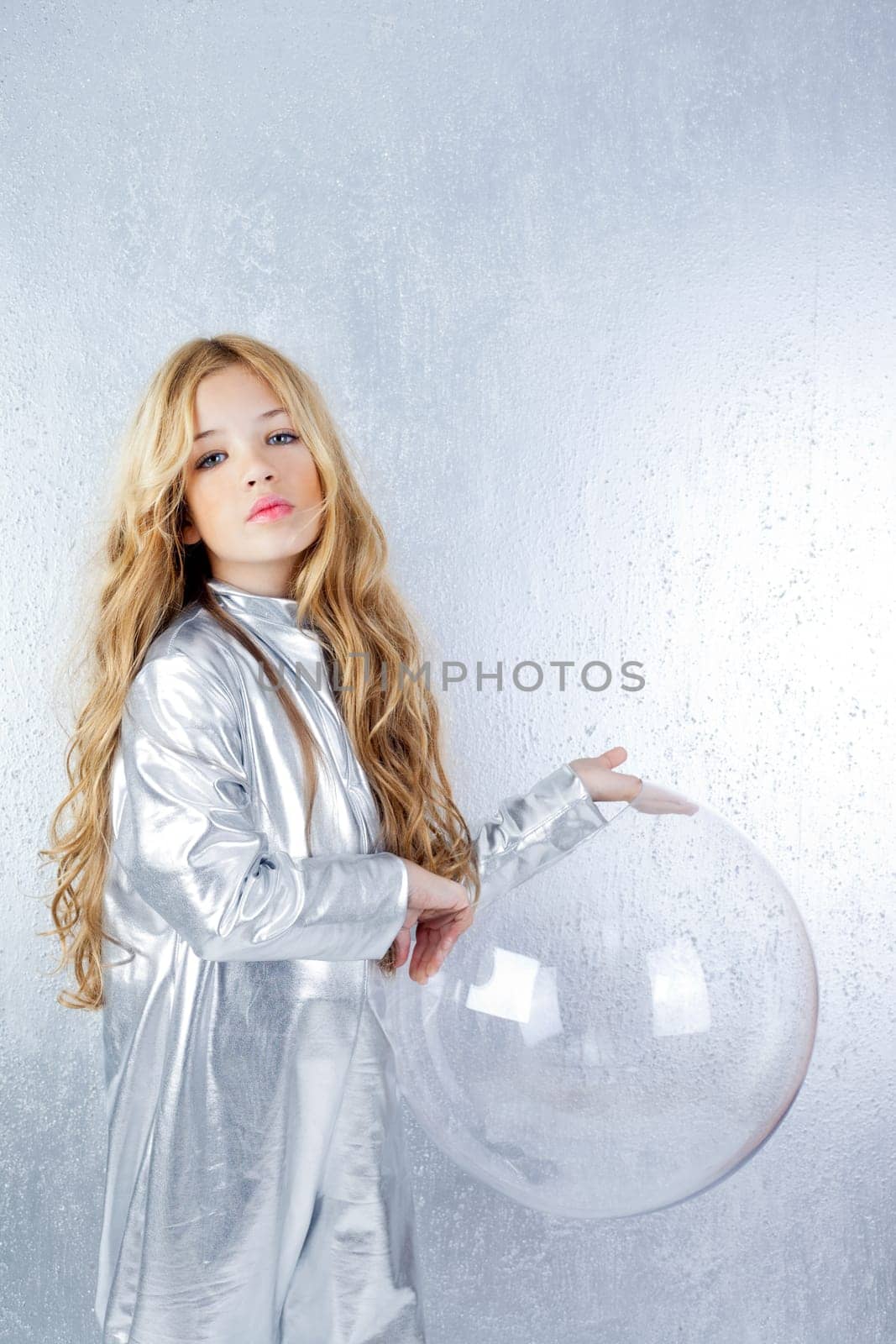 Astronaut futuristic kid girl with silver uniform and glass helmet
