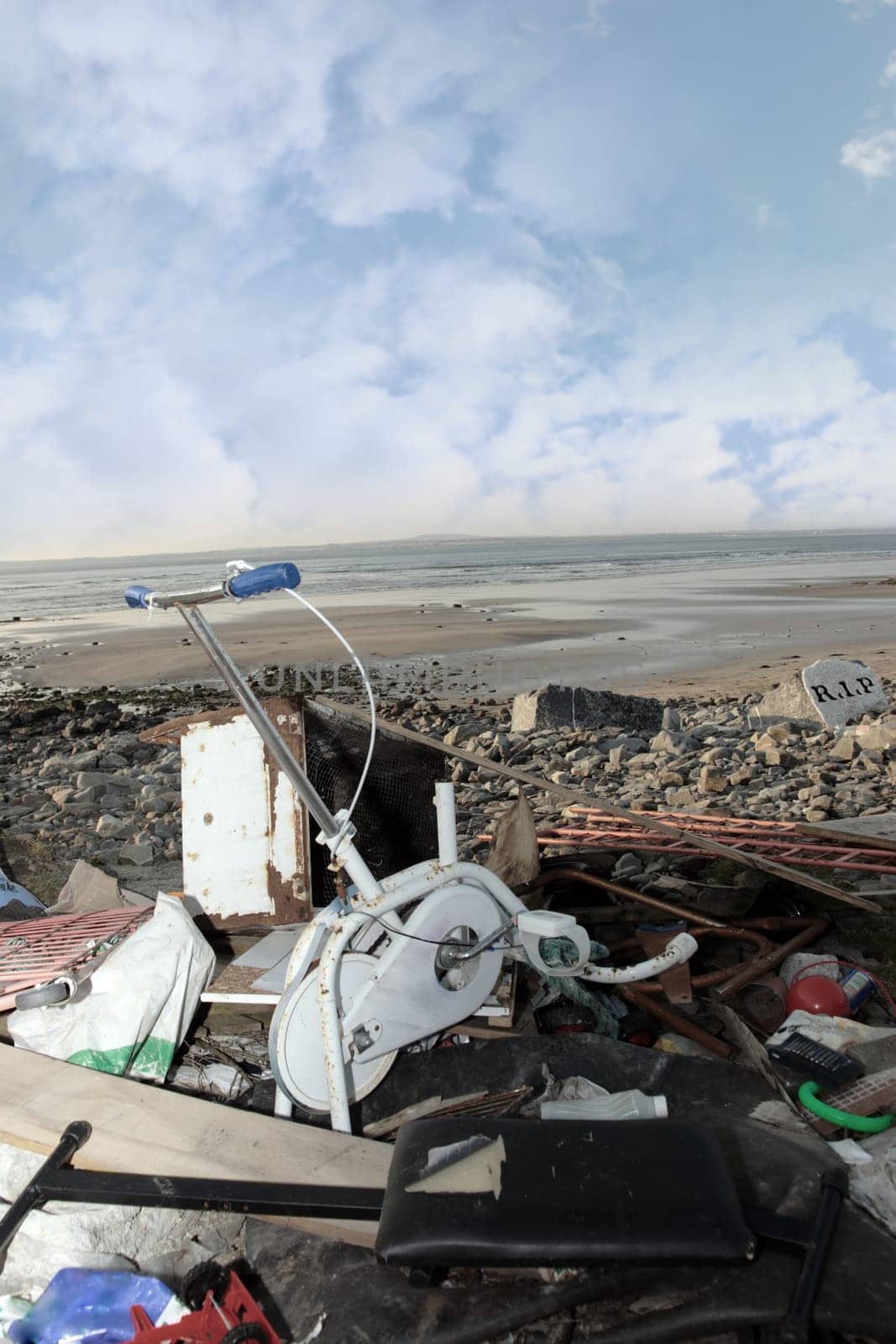 waste discarded and dumped on a beautiful scenic beach