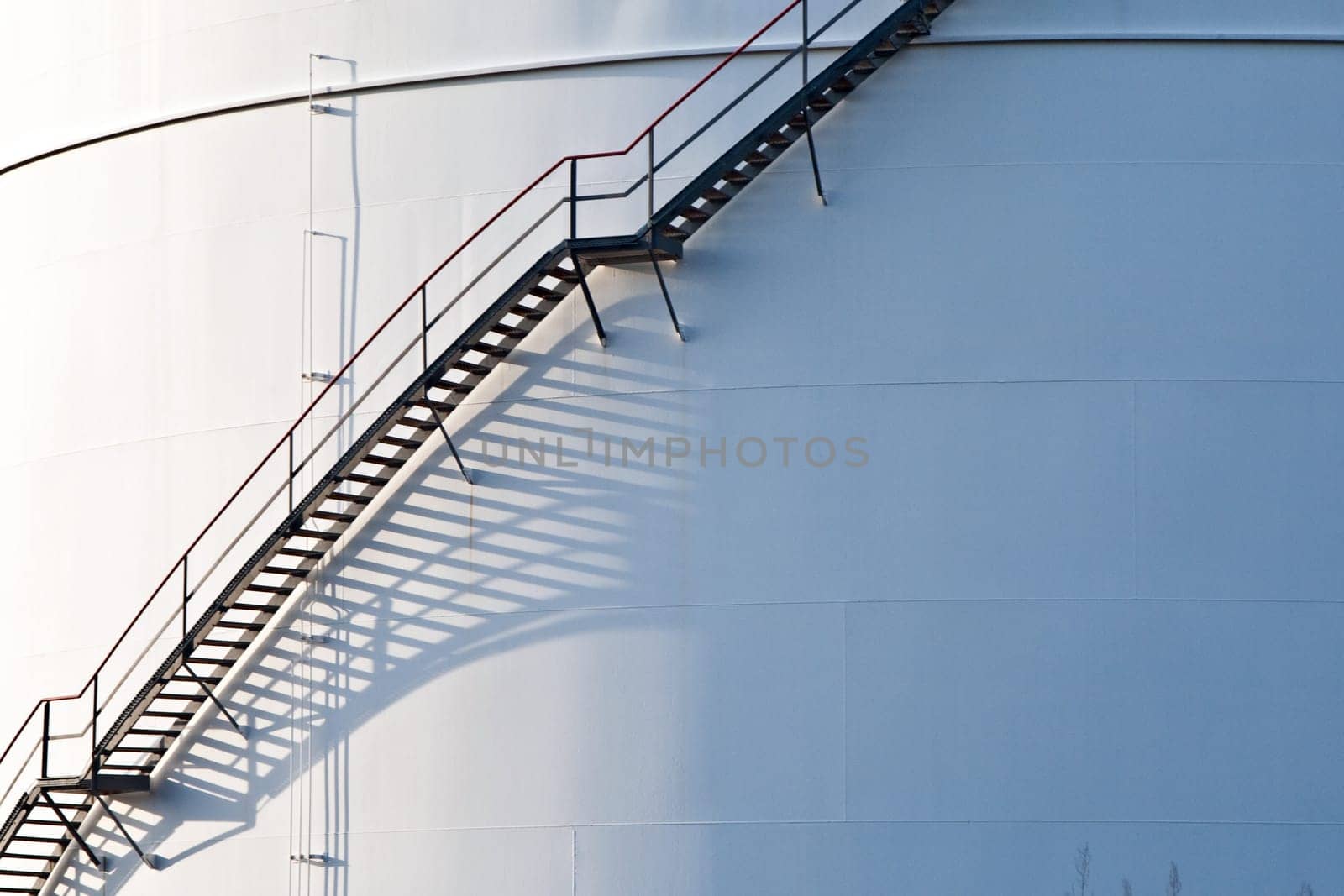 industrial stair at white tank in tank farm