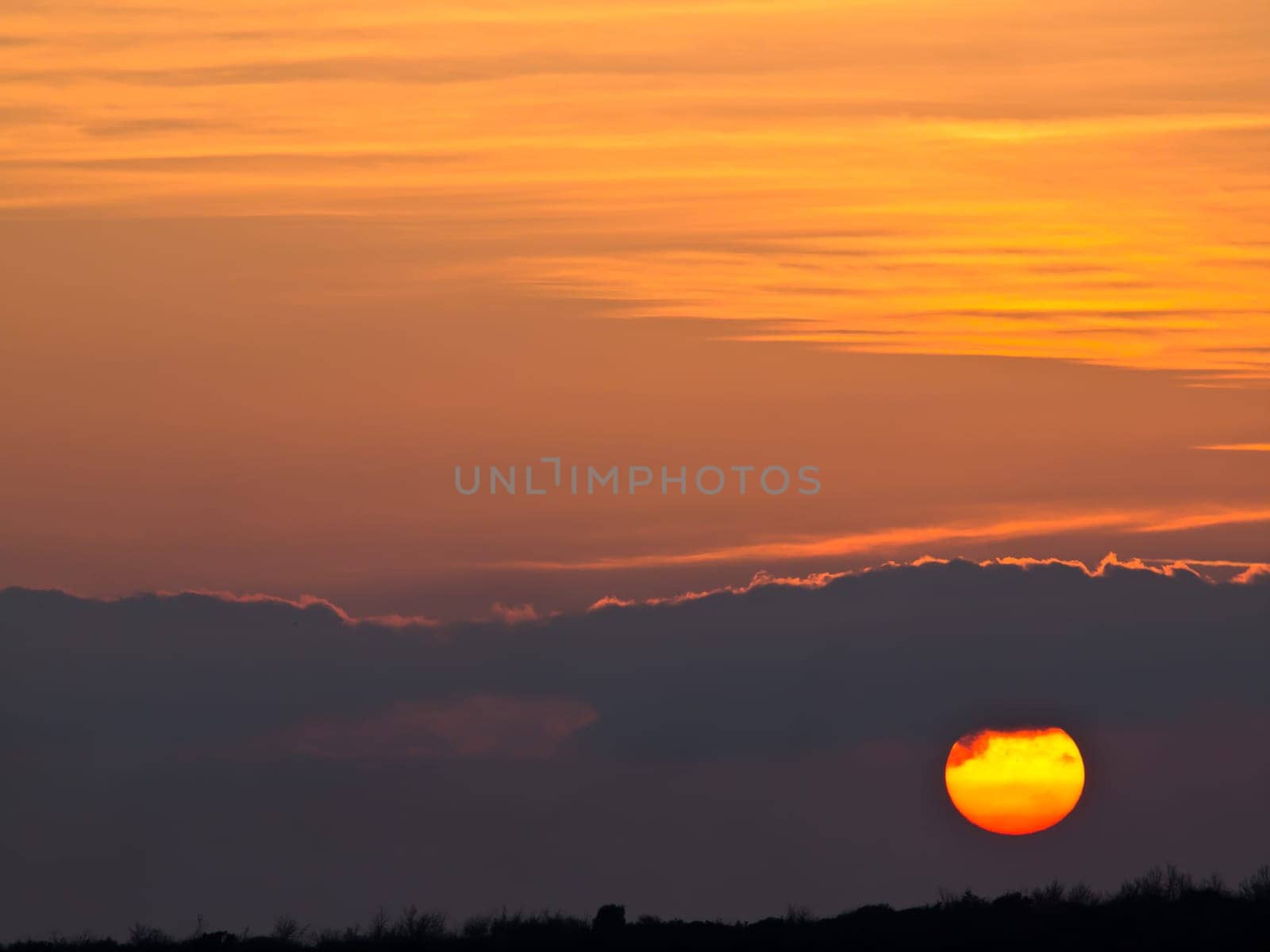sunset with clouds on red sky