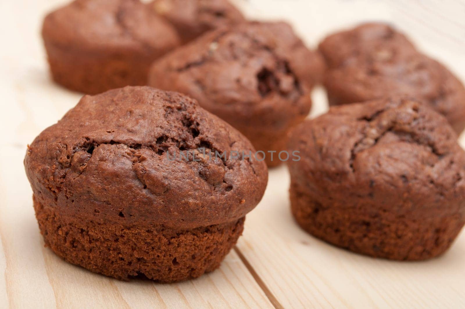 Close Up of Chocolate Muffins on Wooden Table