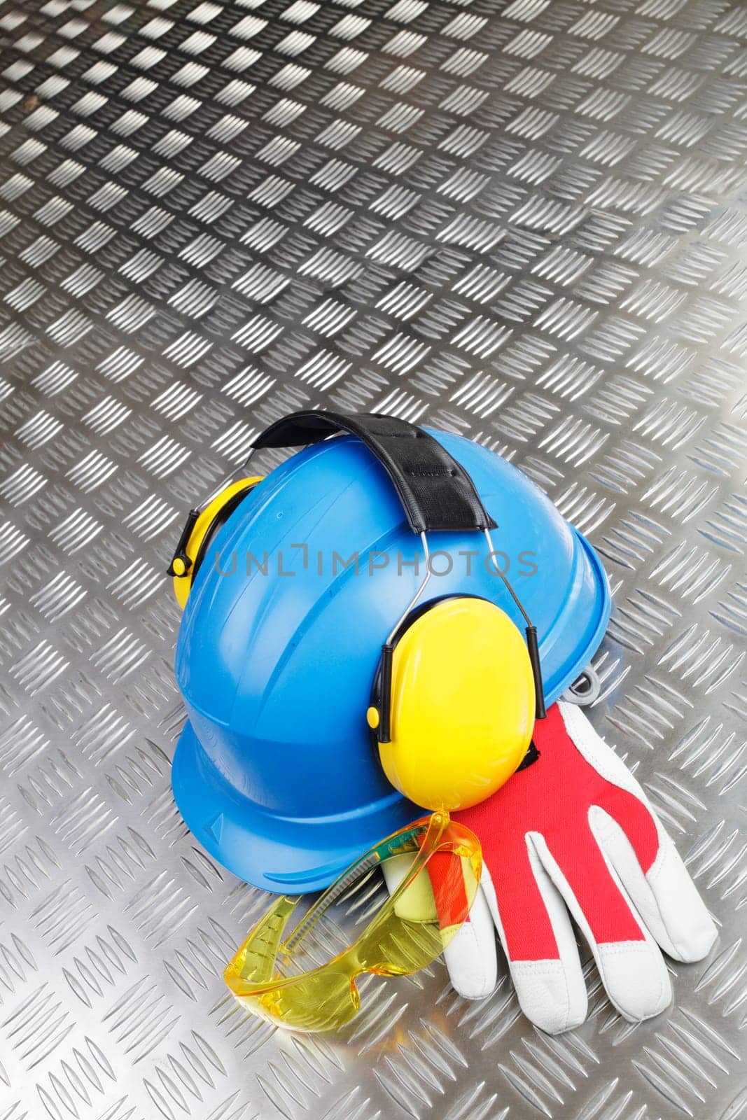 conceptual, hardhat, helmet and gloves against steel background