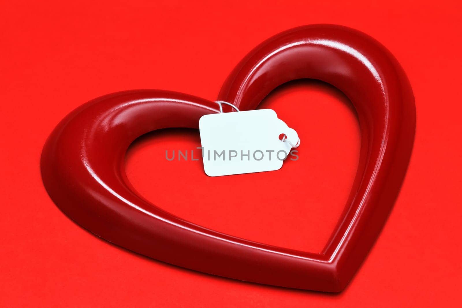 heart shape with tag over red background