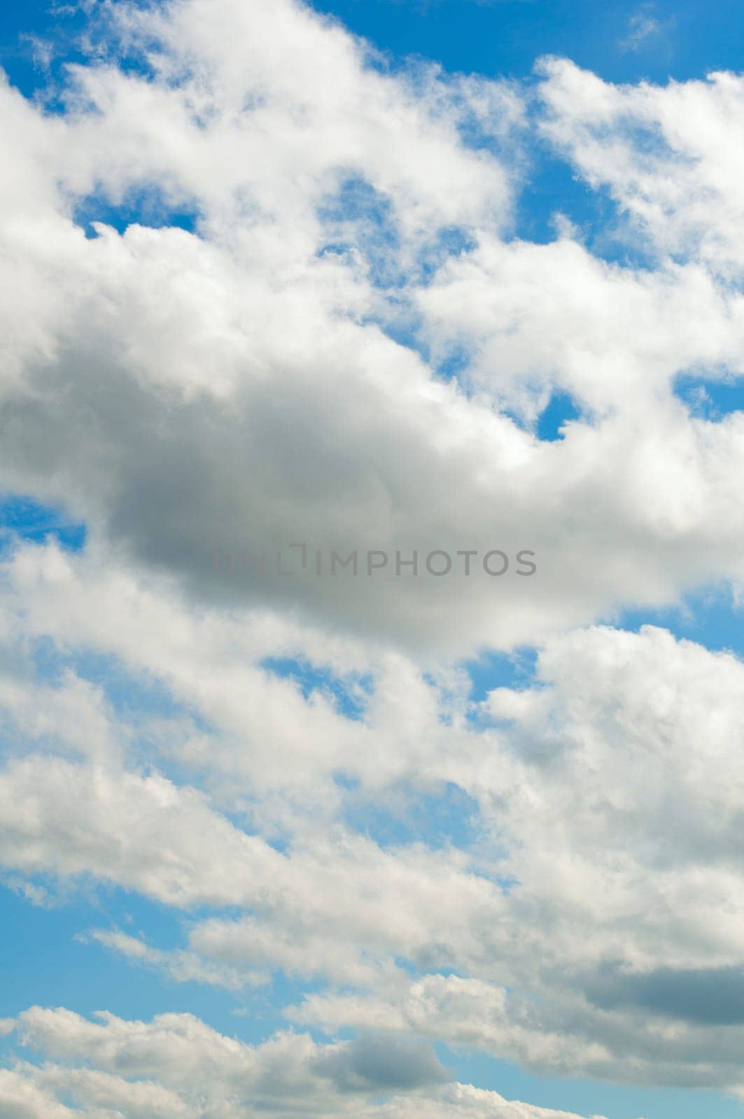Blue summer sky with clouds and sun