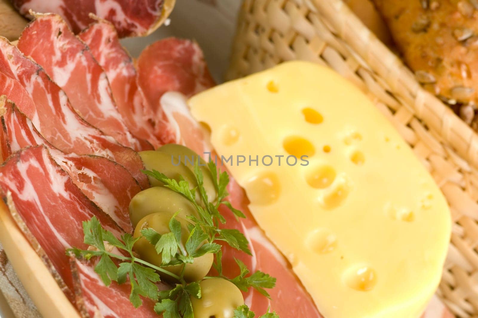 prosciutto, olives, cheese and bread close up