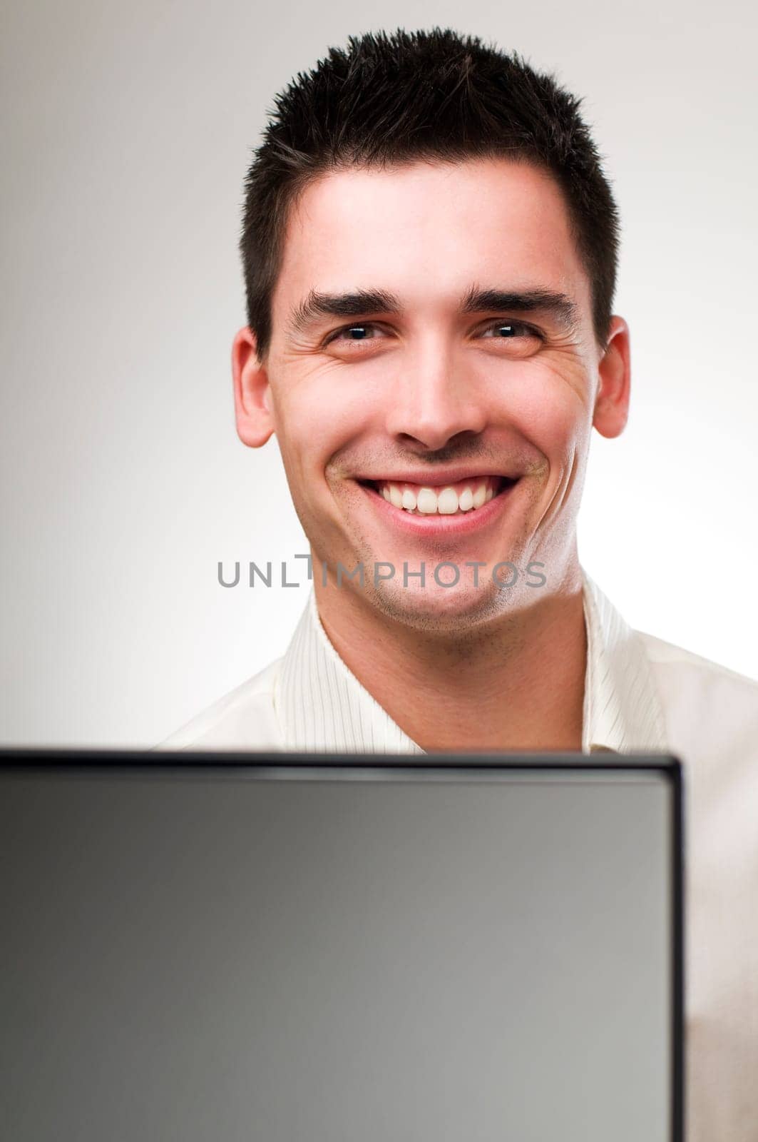 Young business man with laptop close up