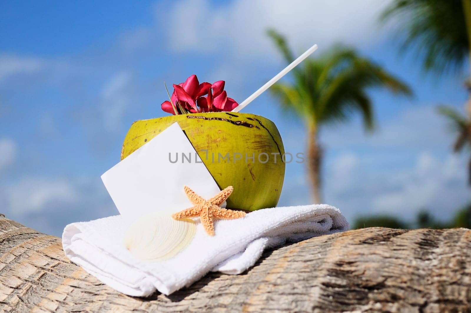 Coconut cocktail starfish tropical Caribbean beach refreshment and towel