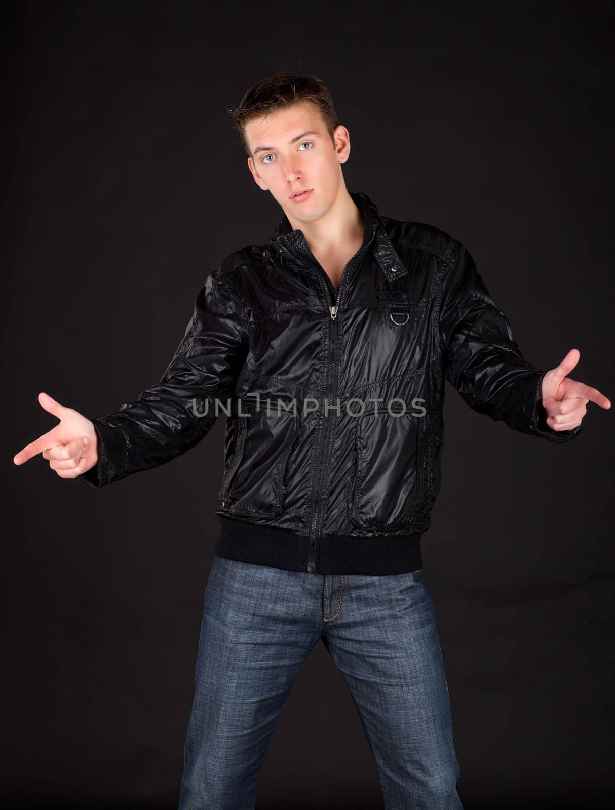 Portrait of a young man sitting on the floor.