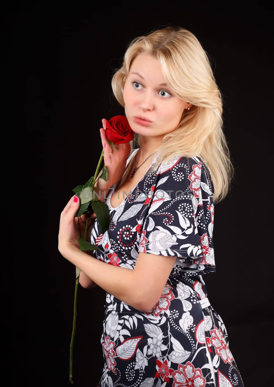 Young blonde woman with red rose.