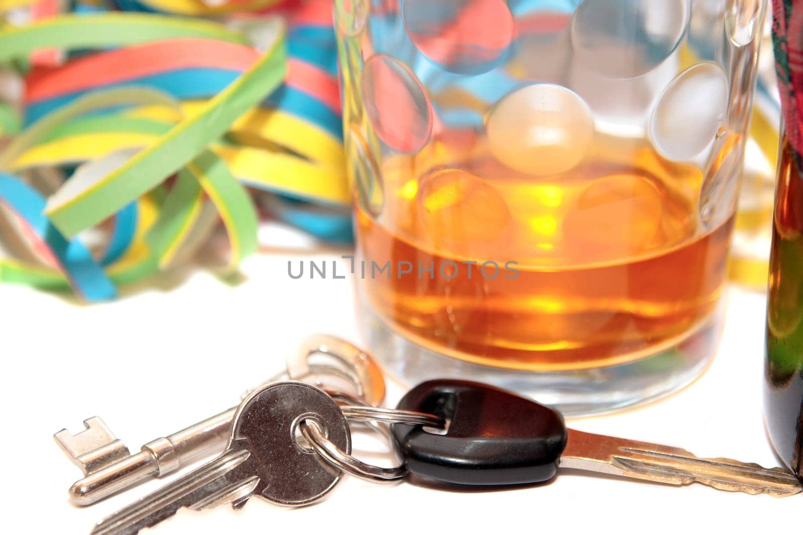 glass of whiskey and car keys on white background depicting drunk driving and addictions can kill
