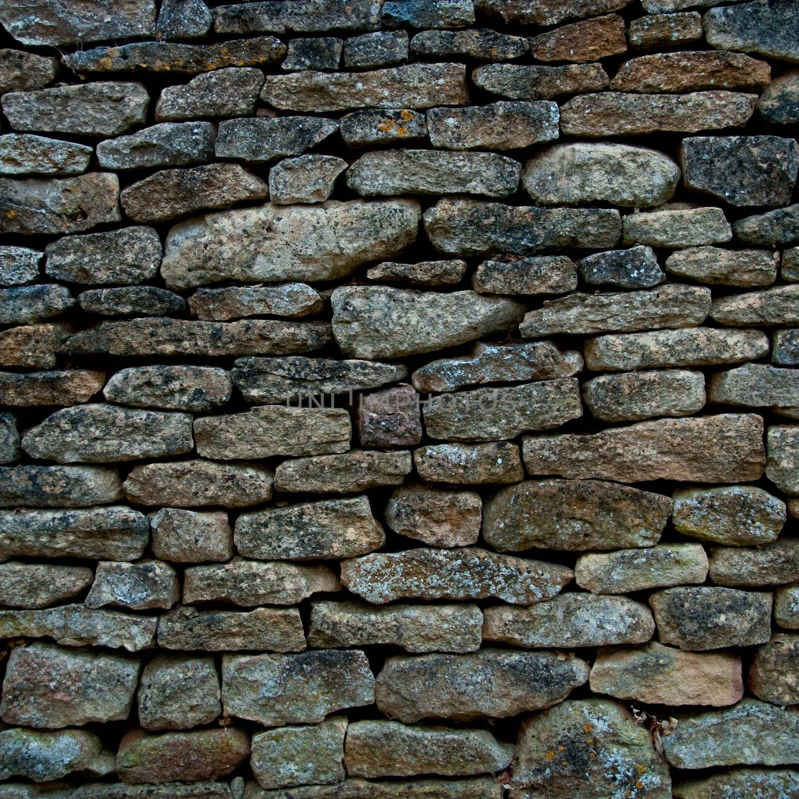 Old and weathered stone wall background, square photography